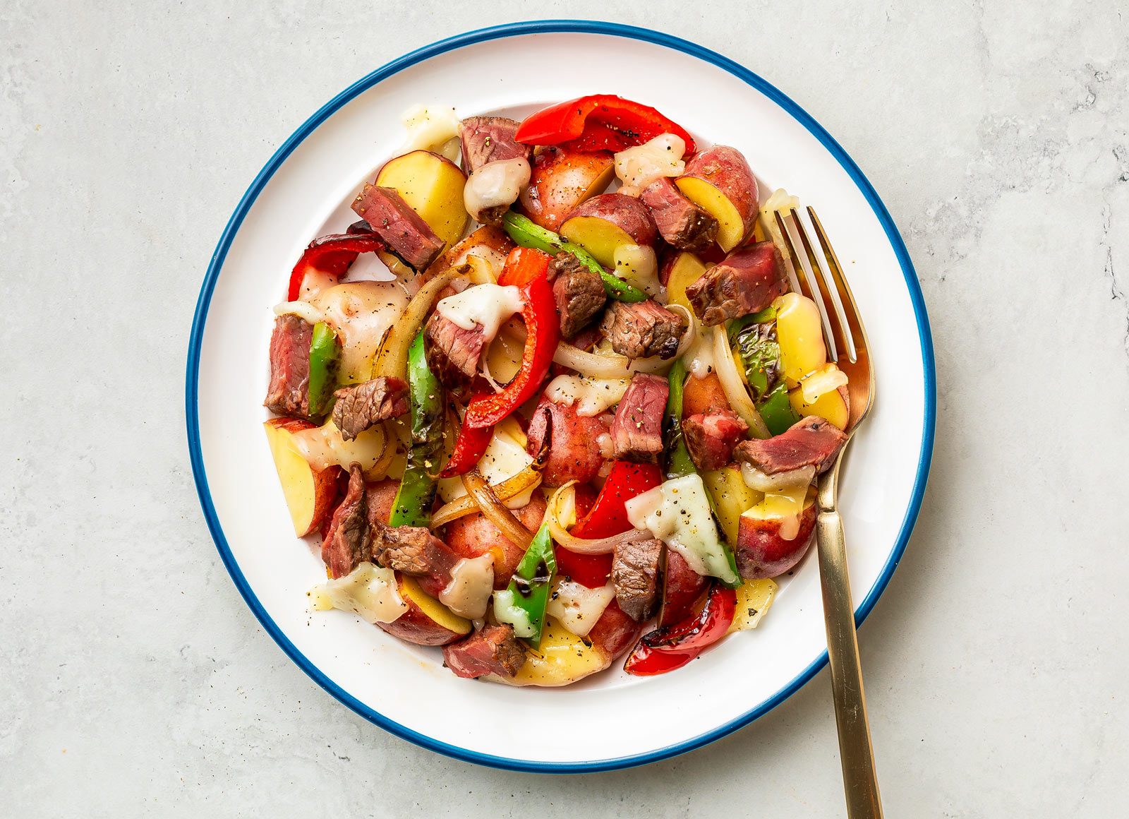 Philly Cheesesteak Potato Nachos with Peppers & Onions