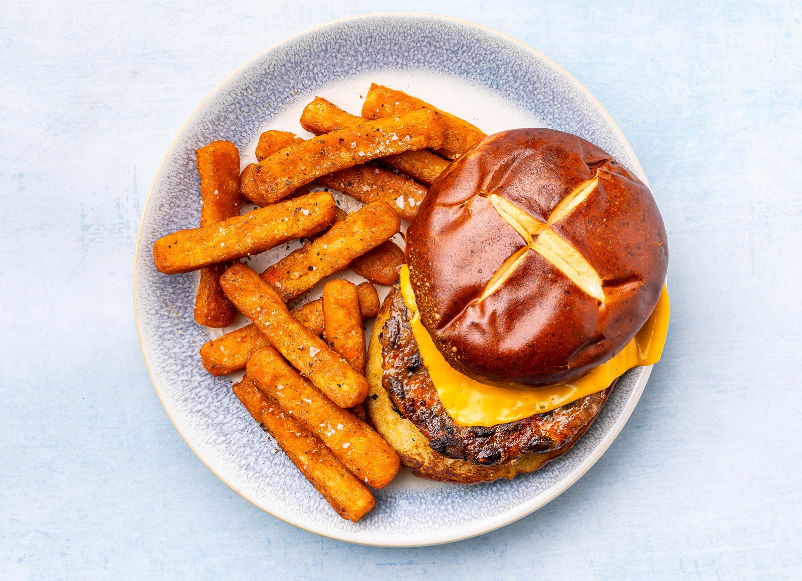 Herby Cheesy Black Bean Burger on Pretzel Bun
