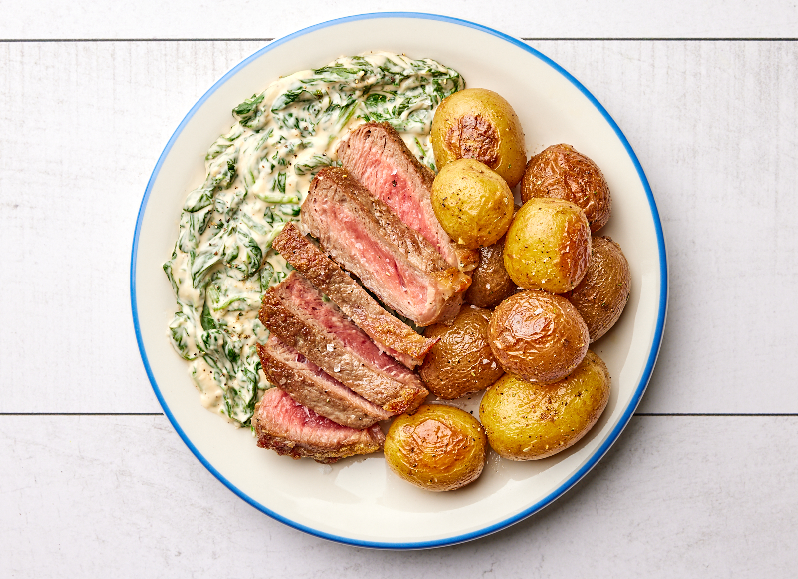 Ribeye Steak with Roasted Potatoes + Cheesy Baby Spinach