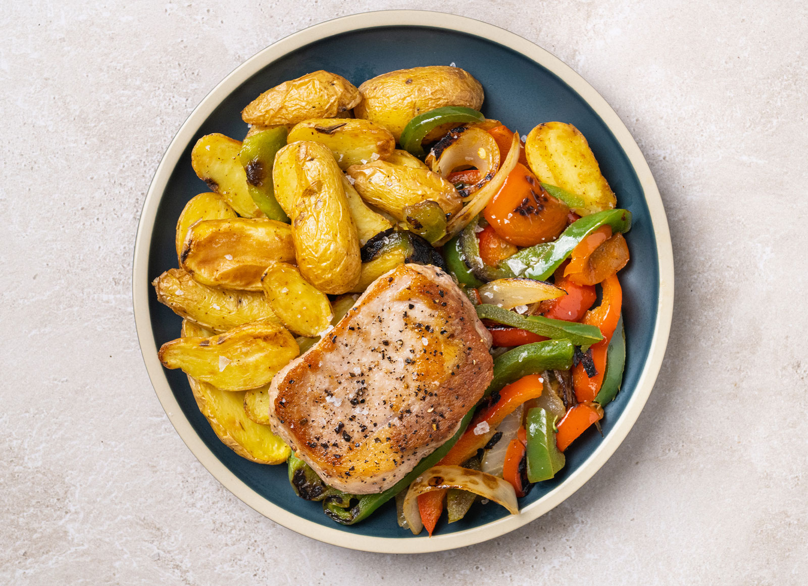 Seared Pork Chop + Roasted Potatoes with Peppers & Onions