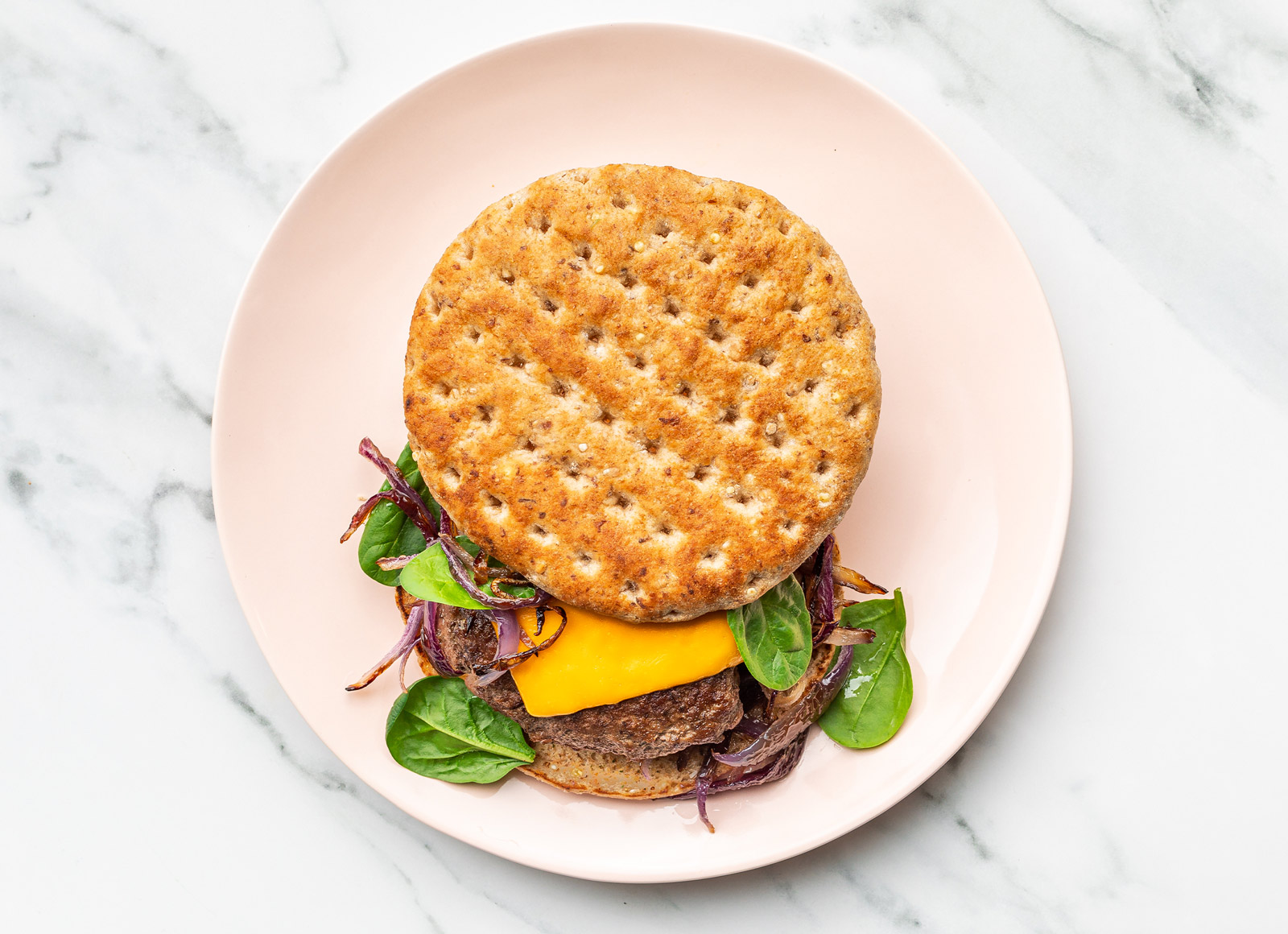 Multigrain Grass-Fed Cheeseburger with Sautéed Onions