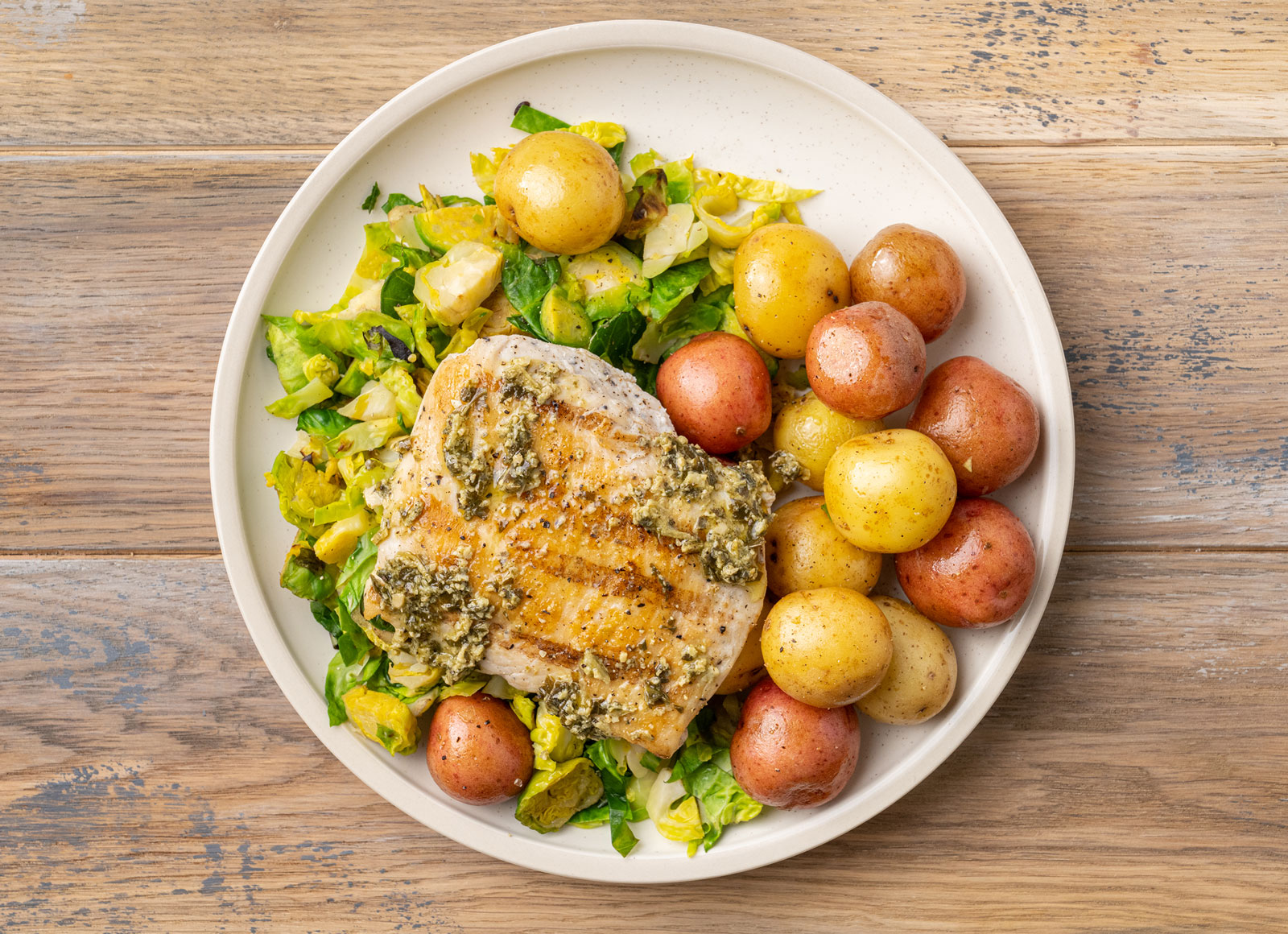 Grilled Pesto Seasoned Chicken Breast with Crispy Brussels