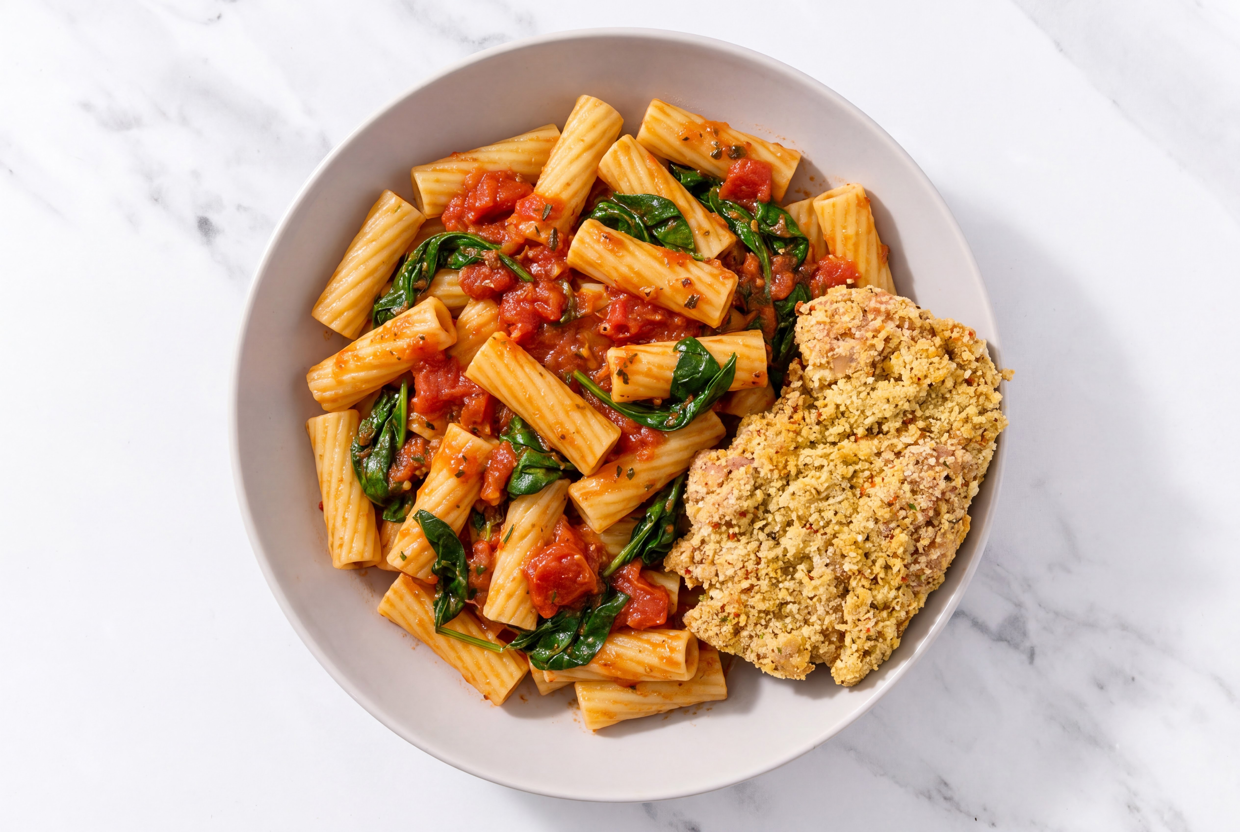 Crispy Garlic Chicken over Marinara Rigatoni with Baby Spinach