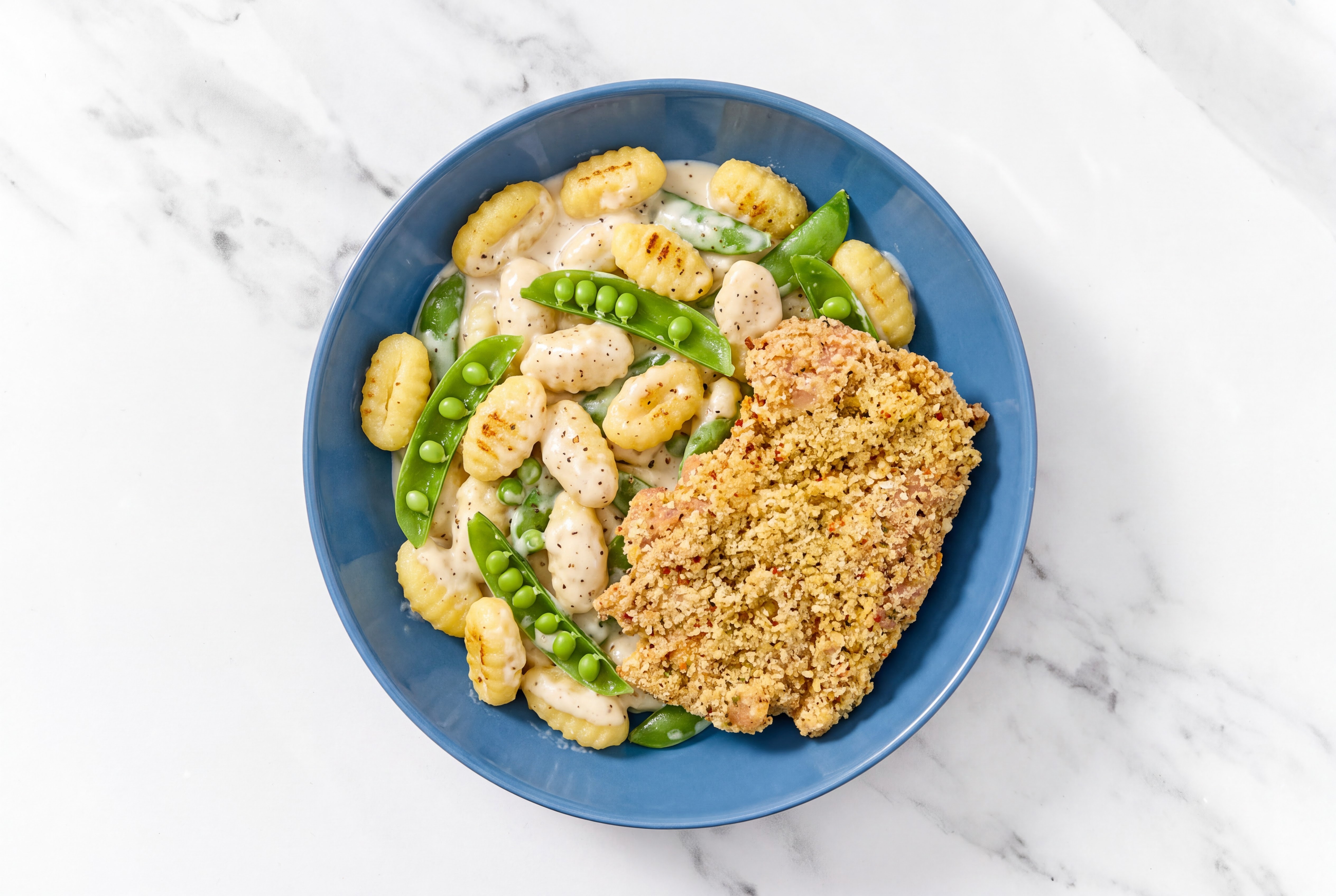 Crispy Garlic Chicken over Alfredo Gnocchi with Snap Peas