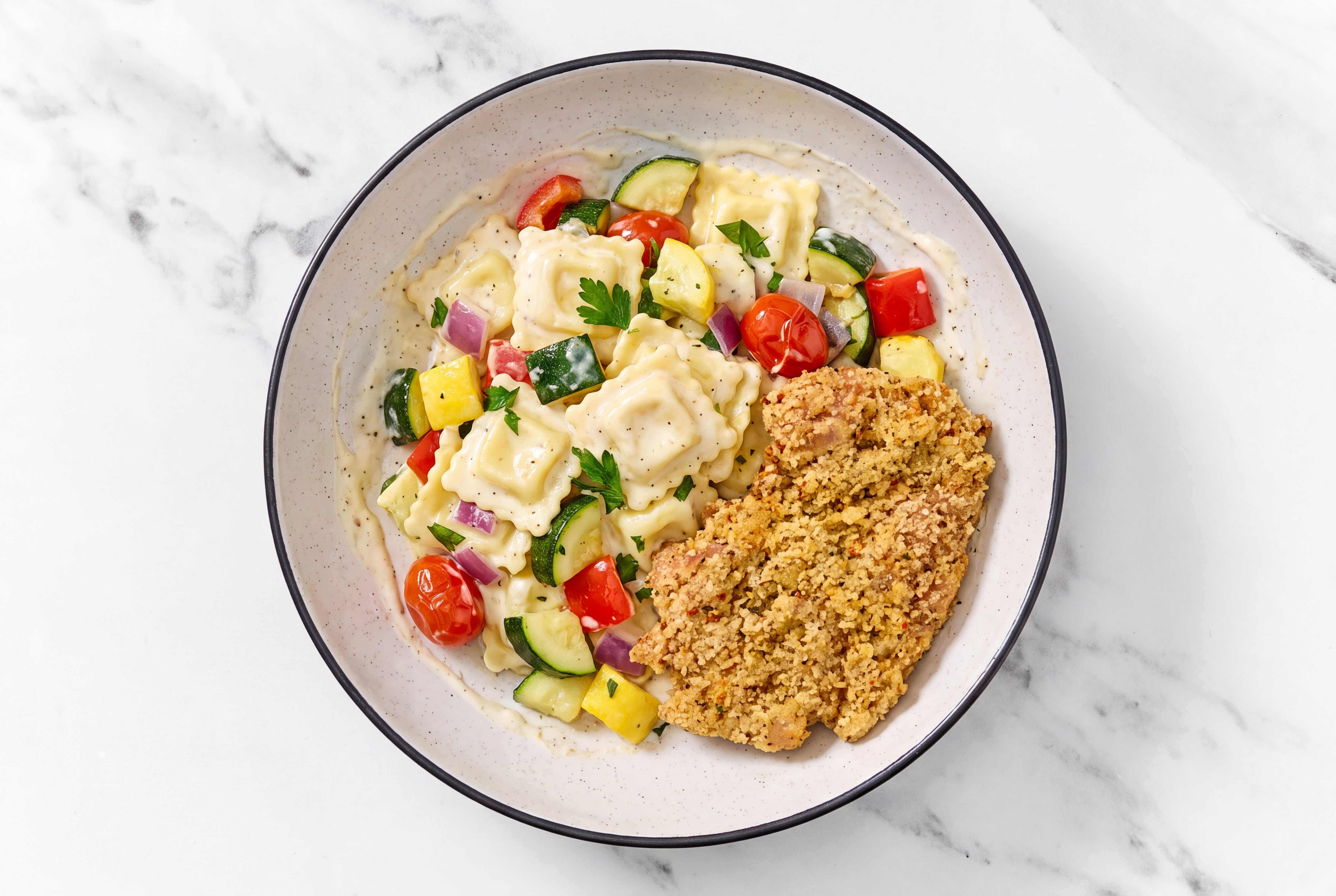 Crispy Garlic Chicken over Alfredo Ravioli with Mixed Veggies