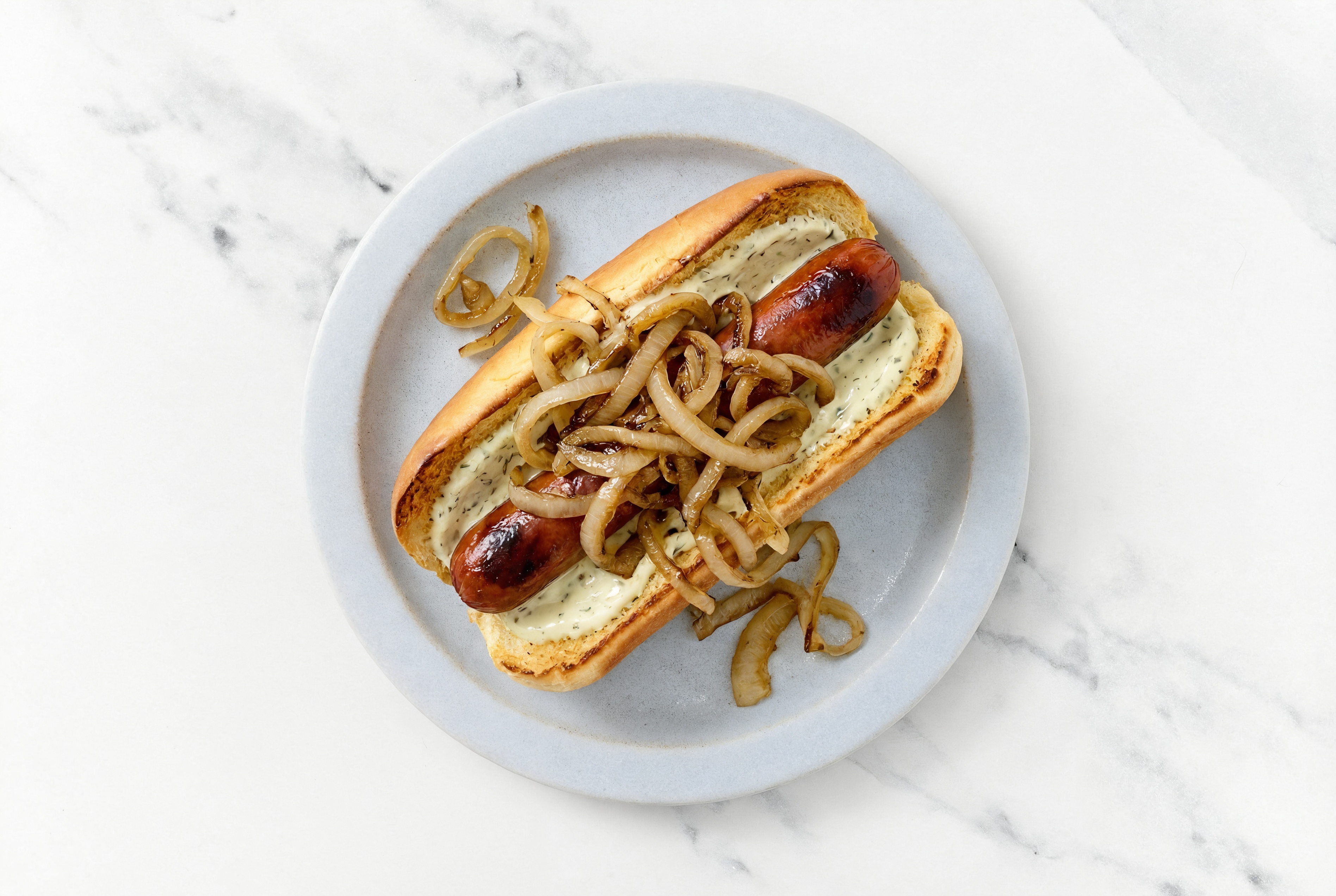 Carmelized Onion Beef Hot Dog with Garlic Sauce on Brioche