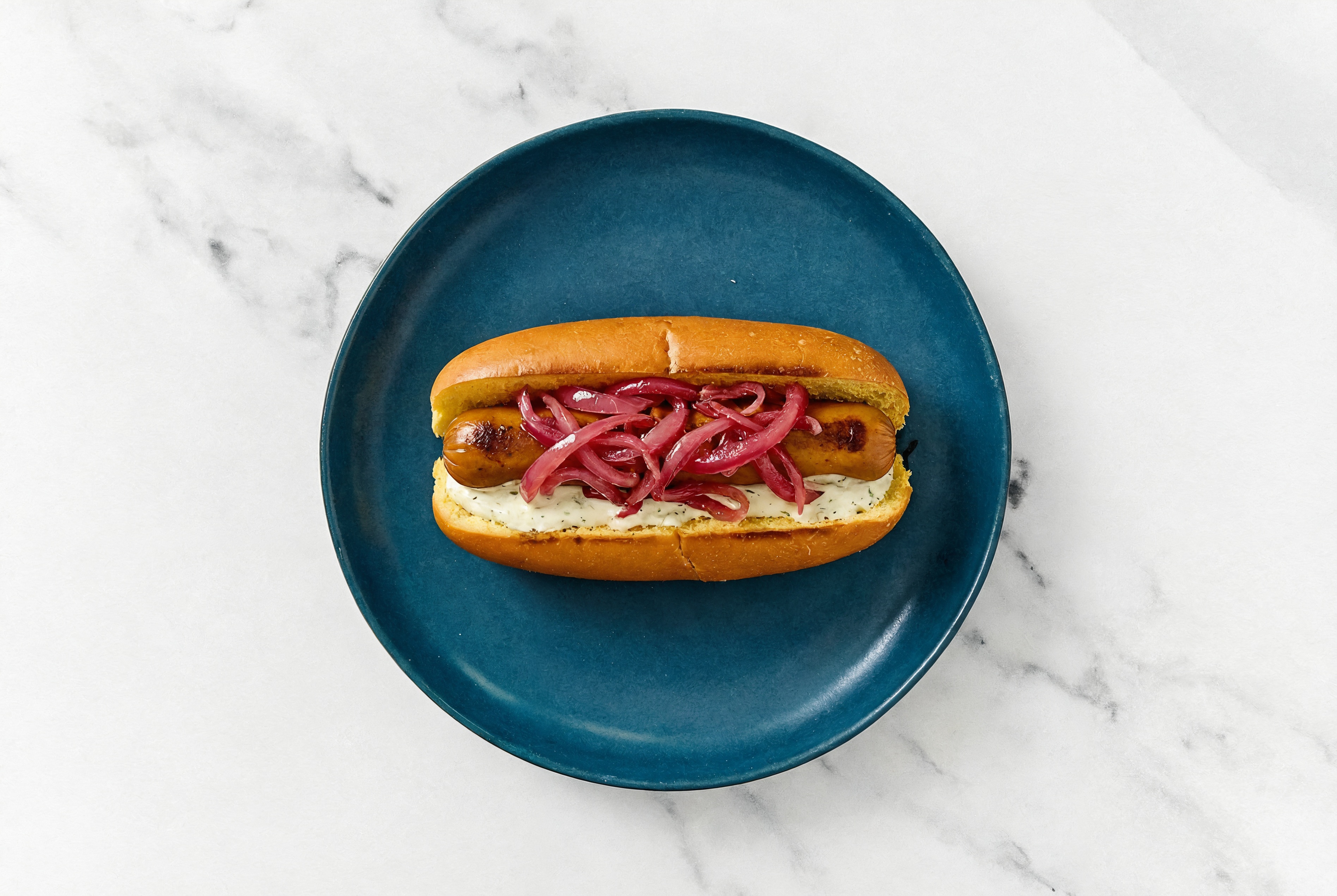 Pickled Red Onion Smart Dog with Garlic Sauce on Brioche