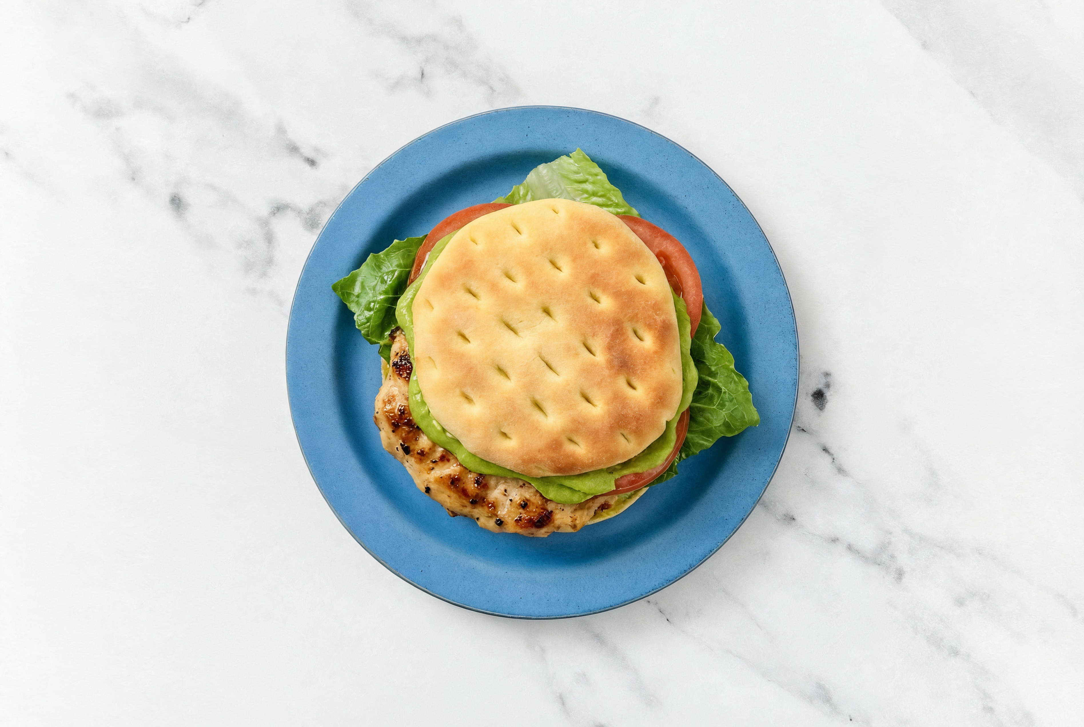 Deluxe Avocado Chicken Bacon Burger on Brioche