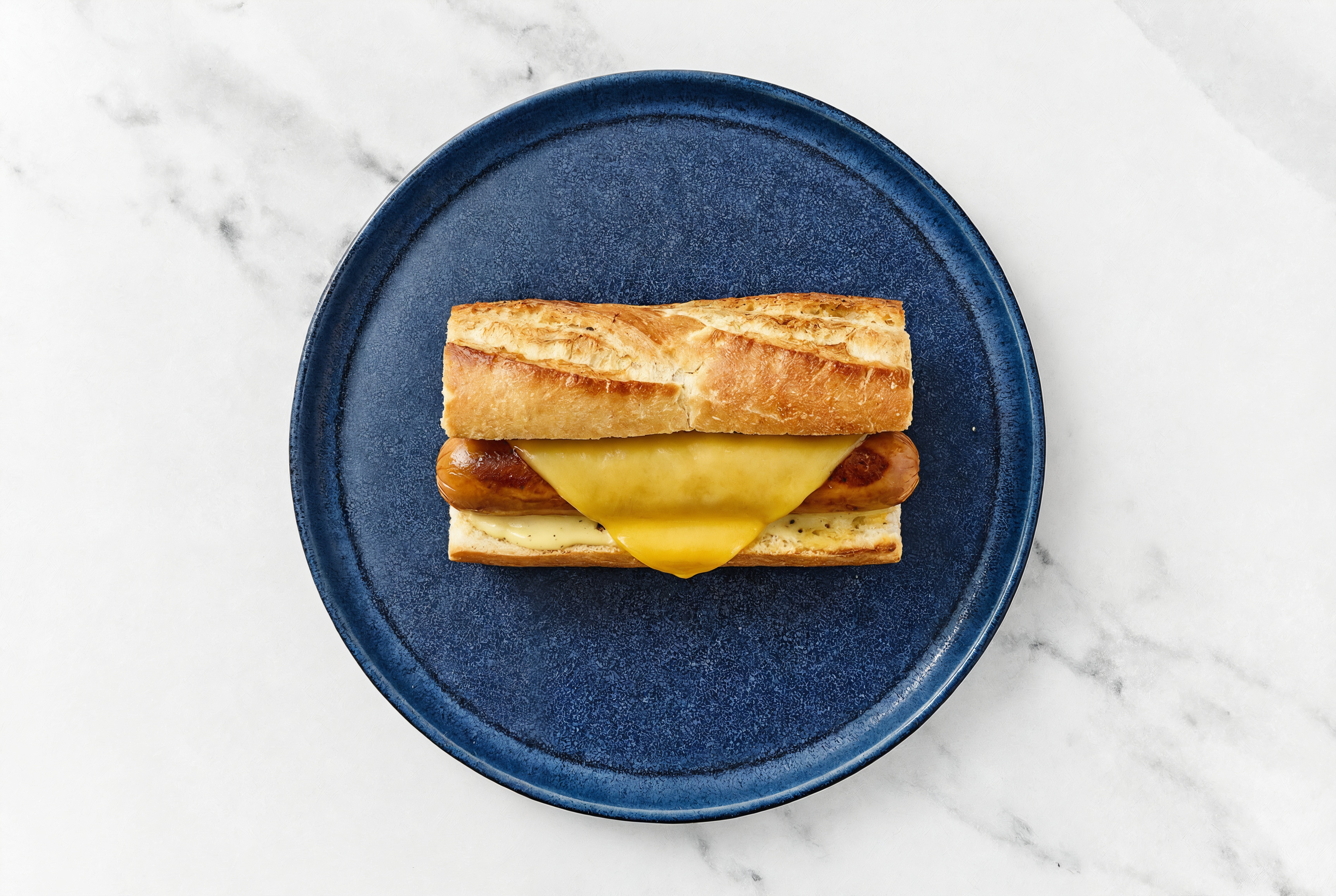 Vegan Cheddar Smart Dog with Honey Musard Garlic Sauce on Baguette
