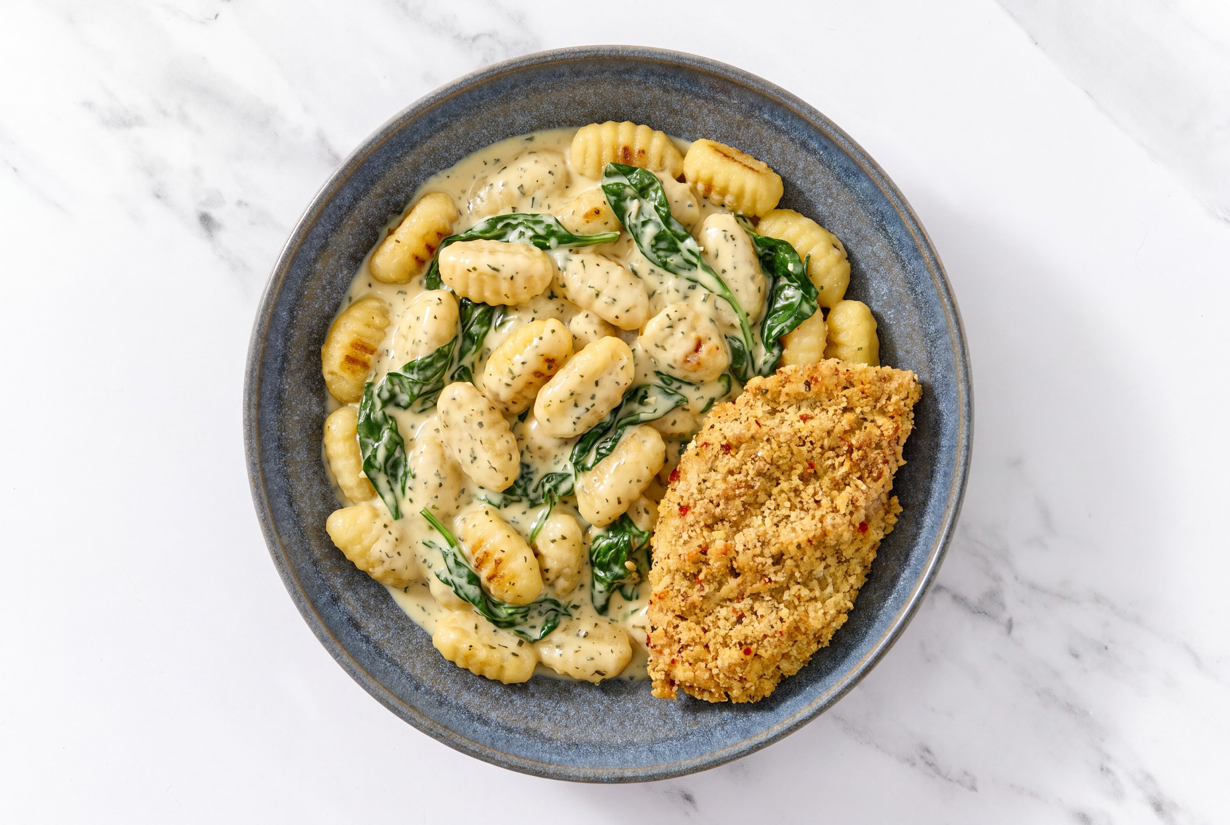 Crispy Garlic Chicken over Creamy Gnocchi with Baby Spinach