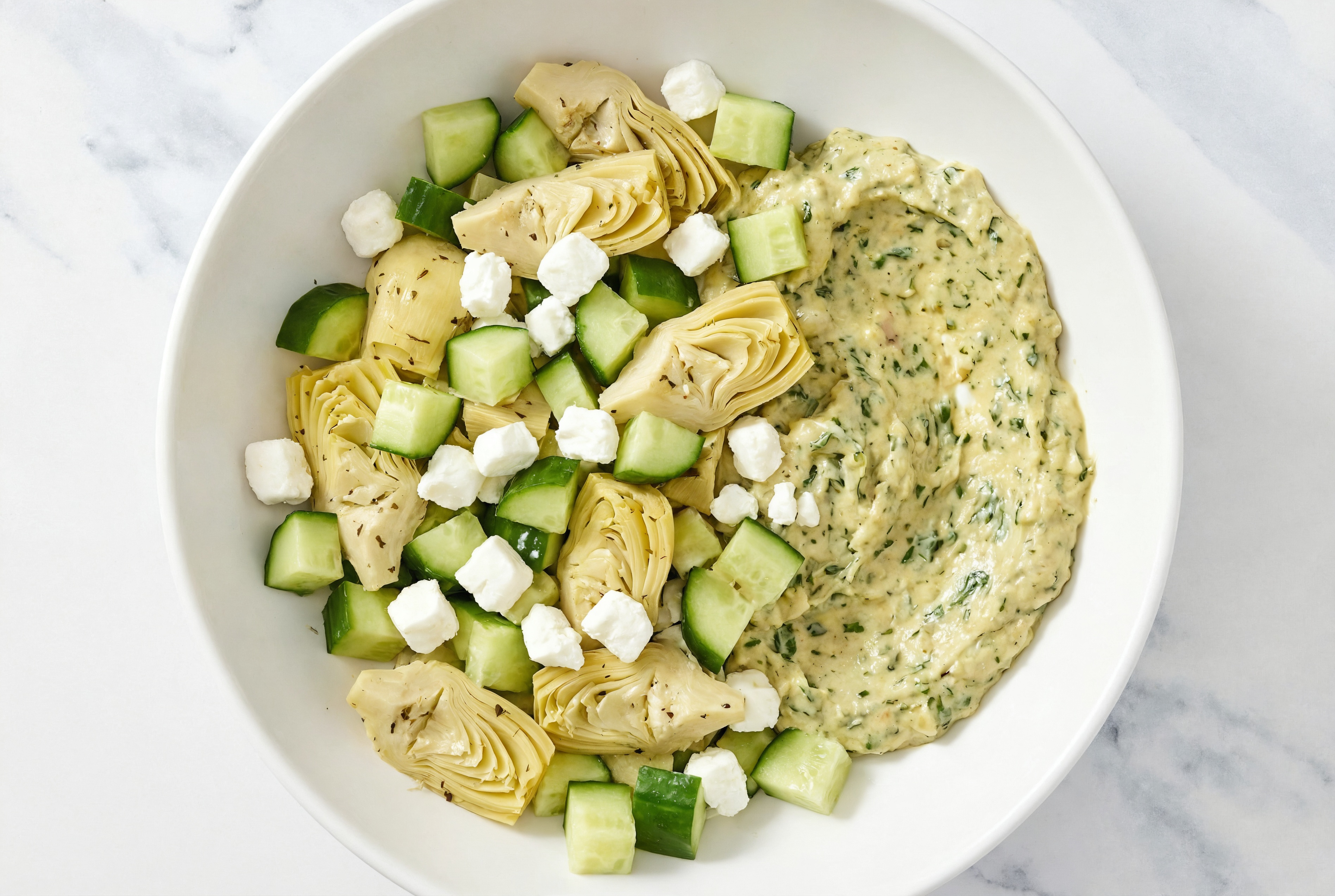Crumbled Chevre Artichoke Cucumber Bowl over Spinach Artichoke Dip