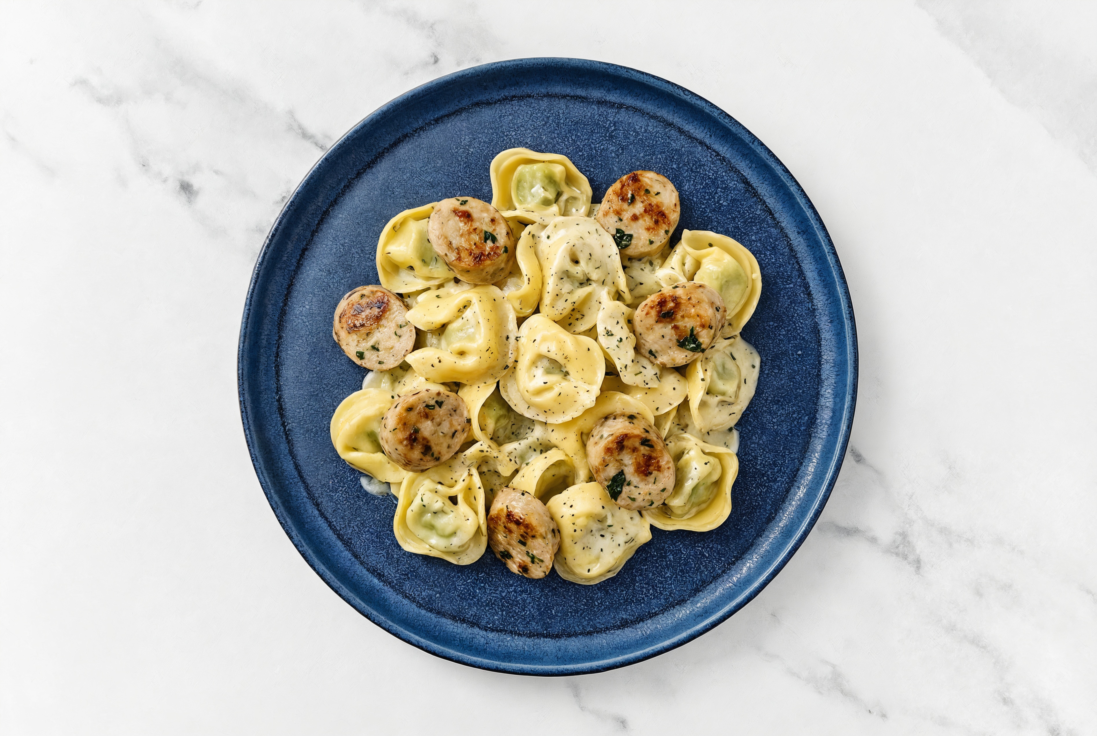 Herb Cream Tortellini with Garlicky Chicken Sausage