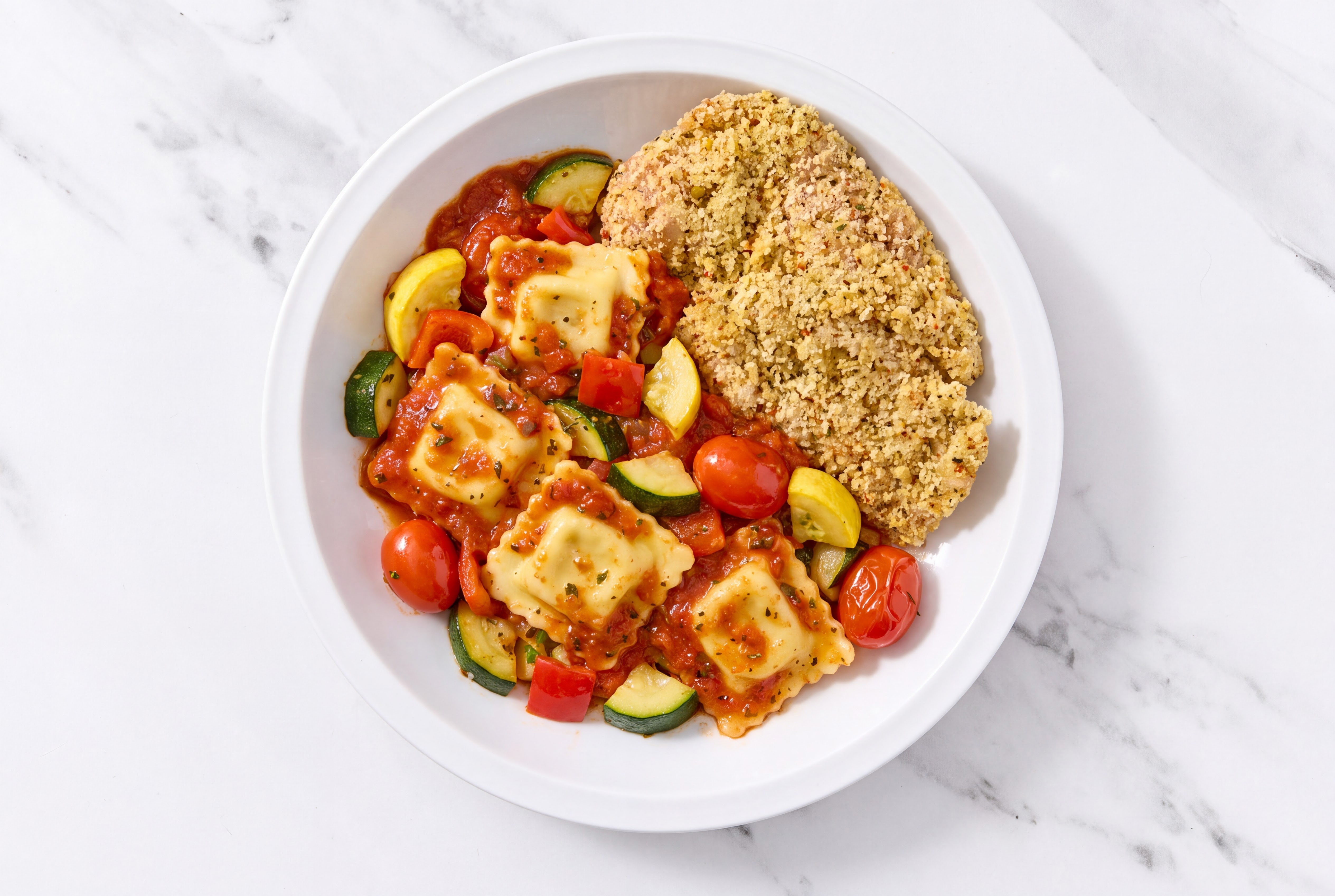 Crispy Garlic Chicken over Marinara Ravioli with Mixed Veggies