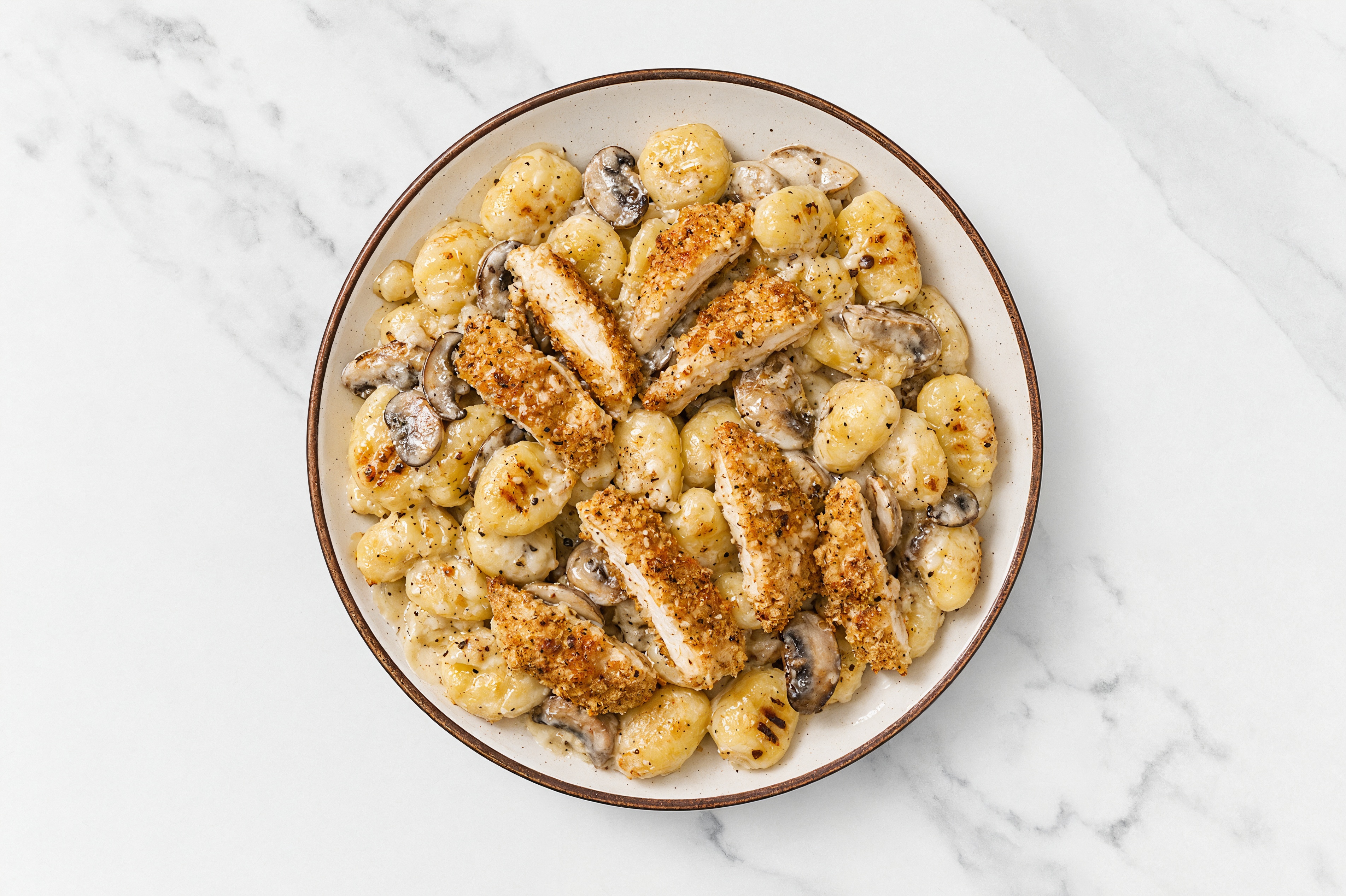 Crispy Garlic Chicken over Alfredo Gnocchi with Baby Bella Mushrooms