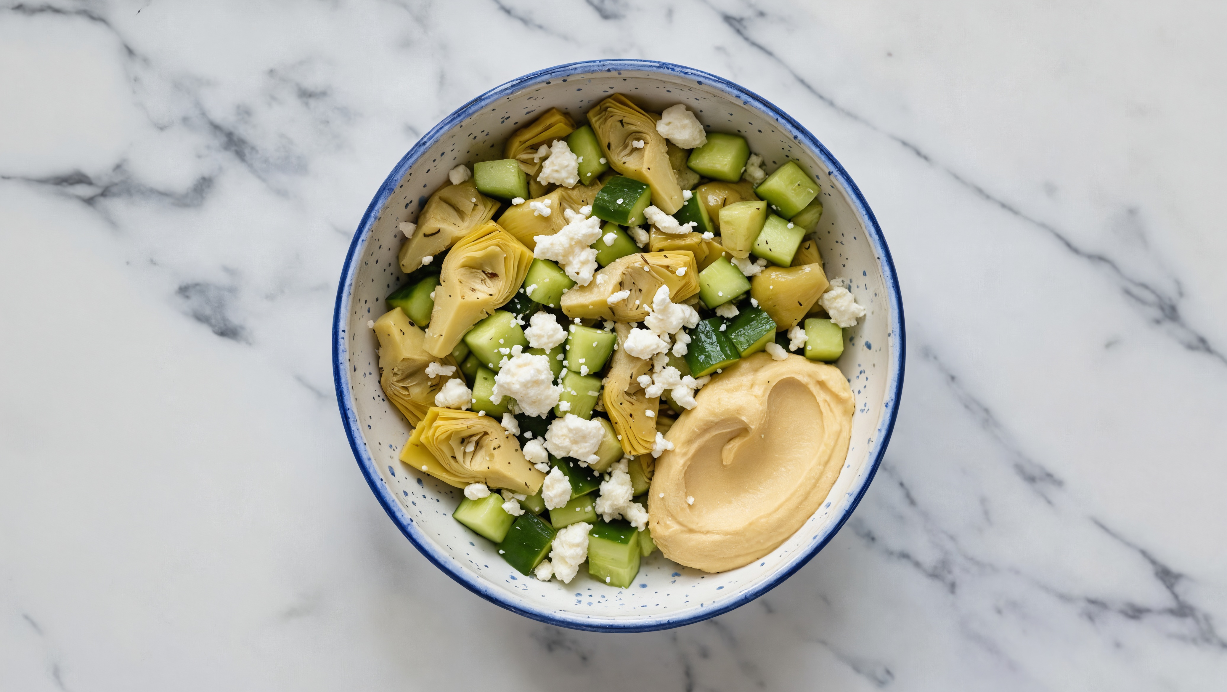 Crumbled Chevre Artichoke Cucumber Bowl over Lemon Garlic Hummus