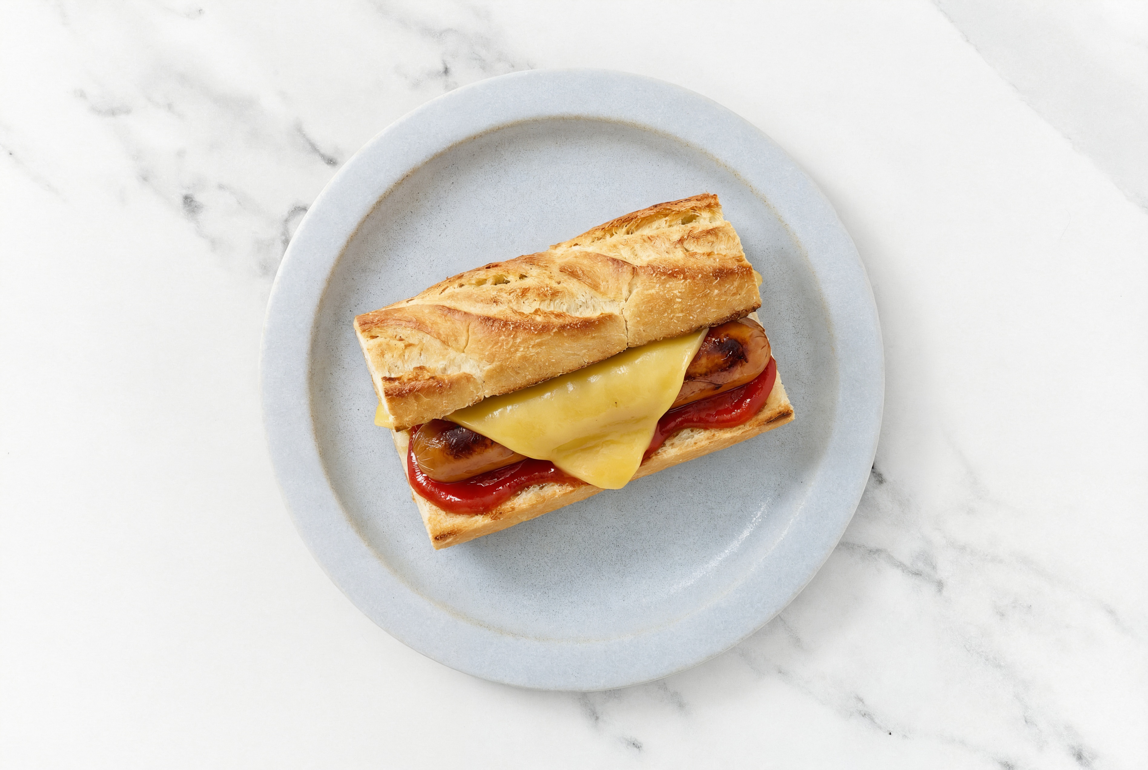 Vegan Cheddar Smart Dog with Ketchup on Baguette