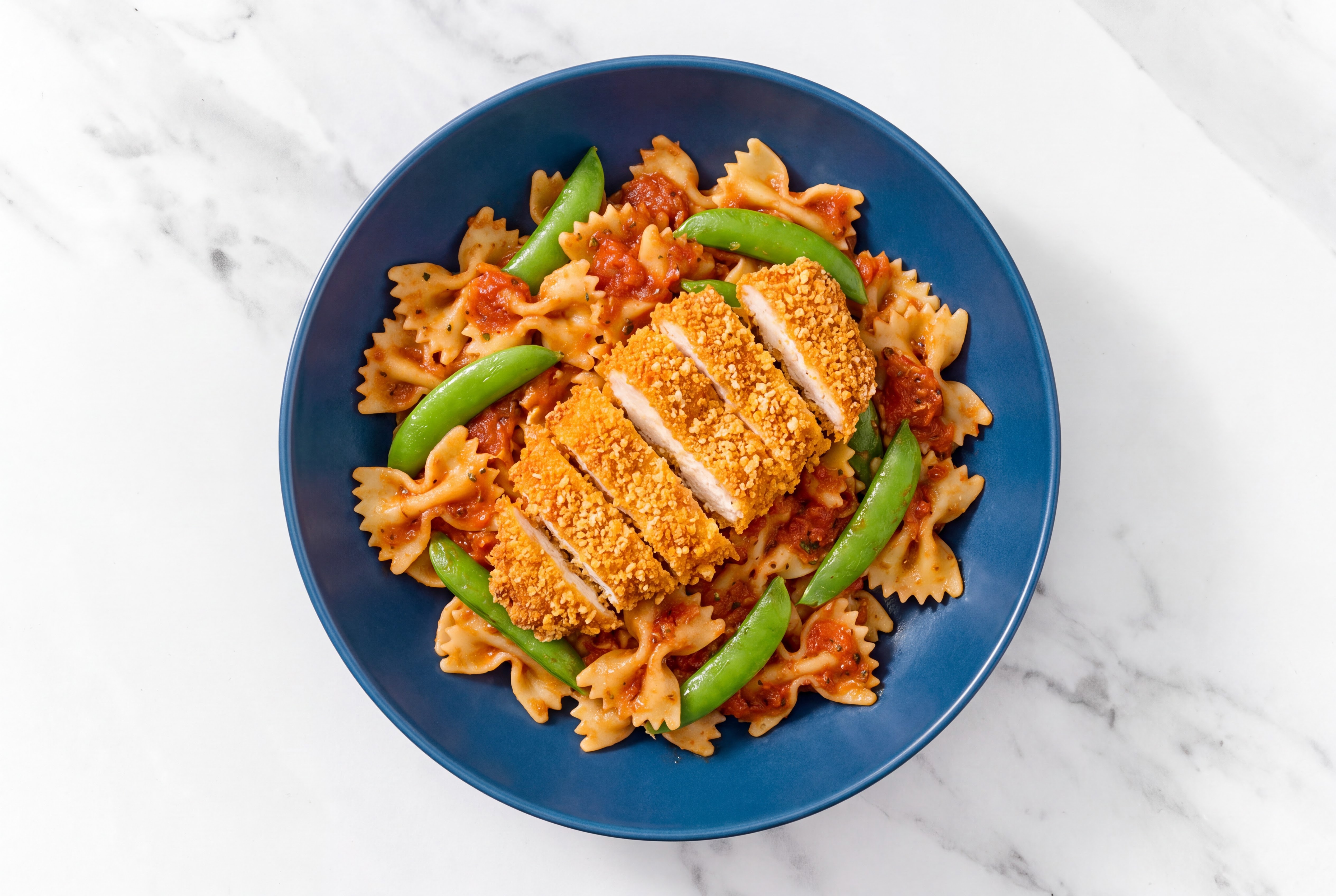 Crispy Hot Honey Chicken over Marinara Farfalle with Snap Peas