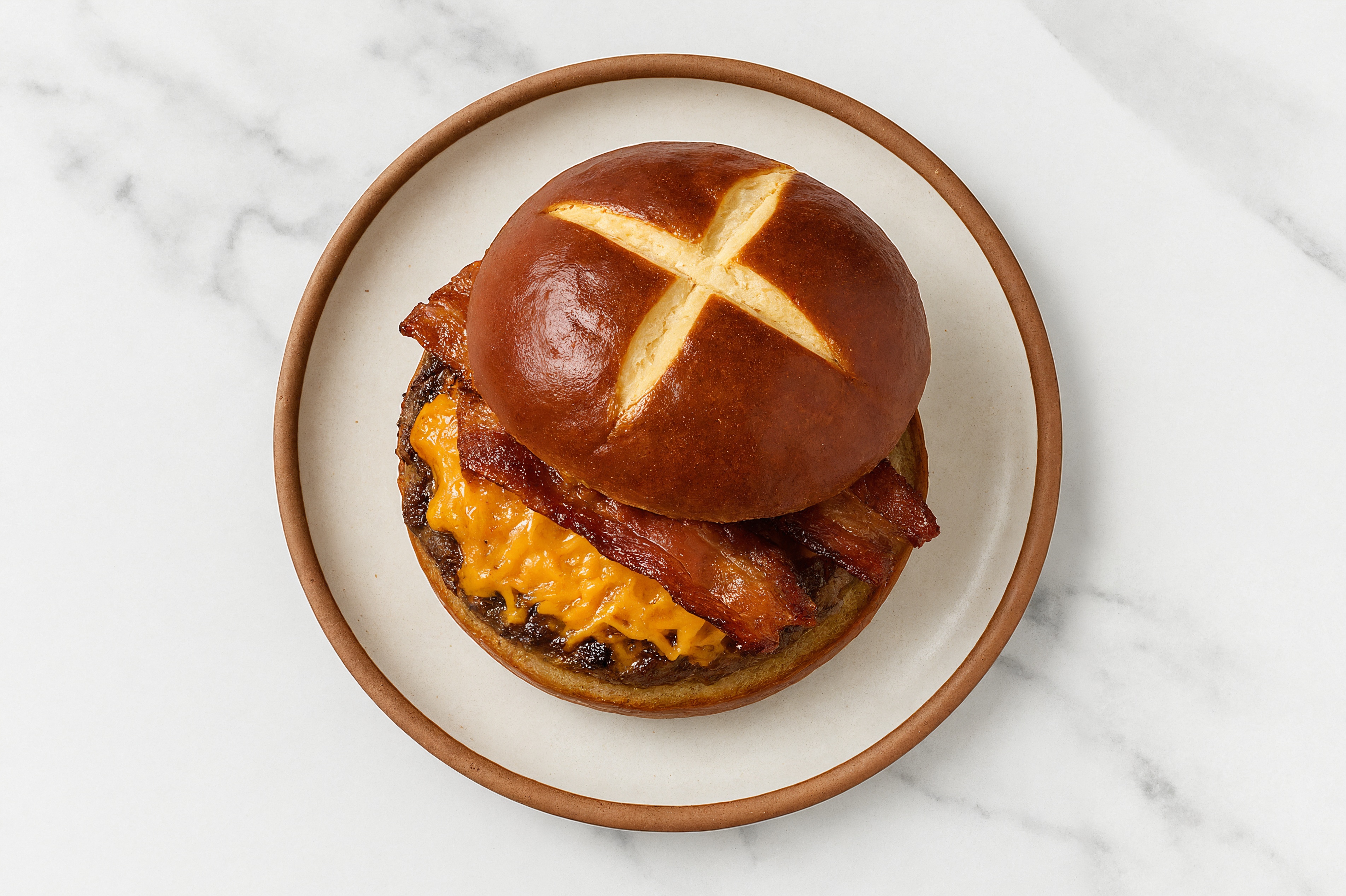 Juicy Maple Bacon Brisket Cheeseburger on Pretzel Bun with Shredded Sharp Cheddar Cheese