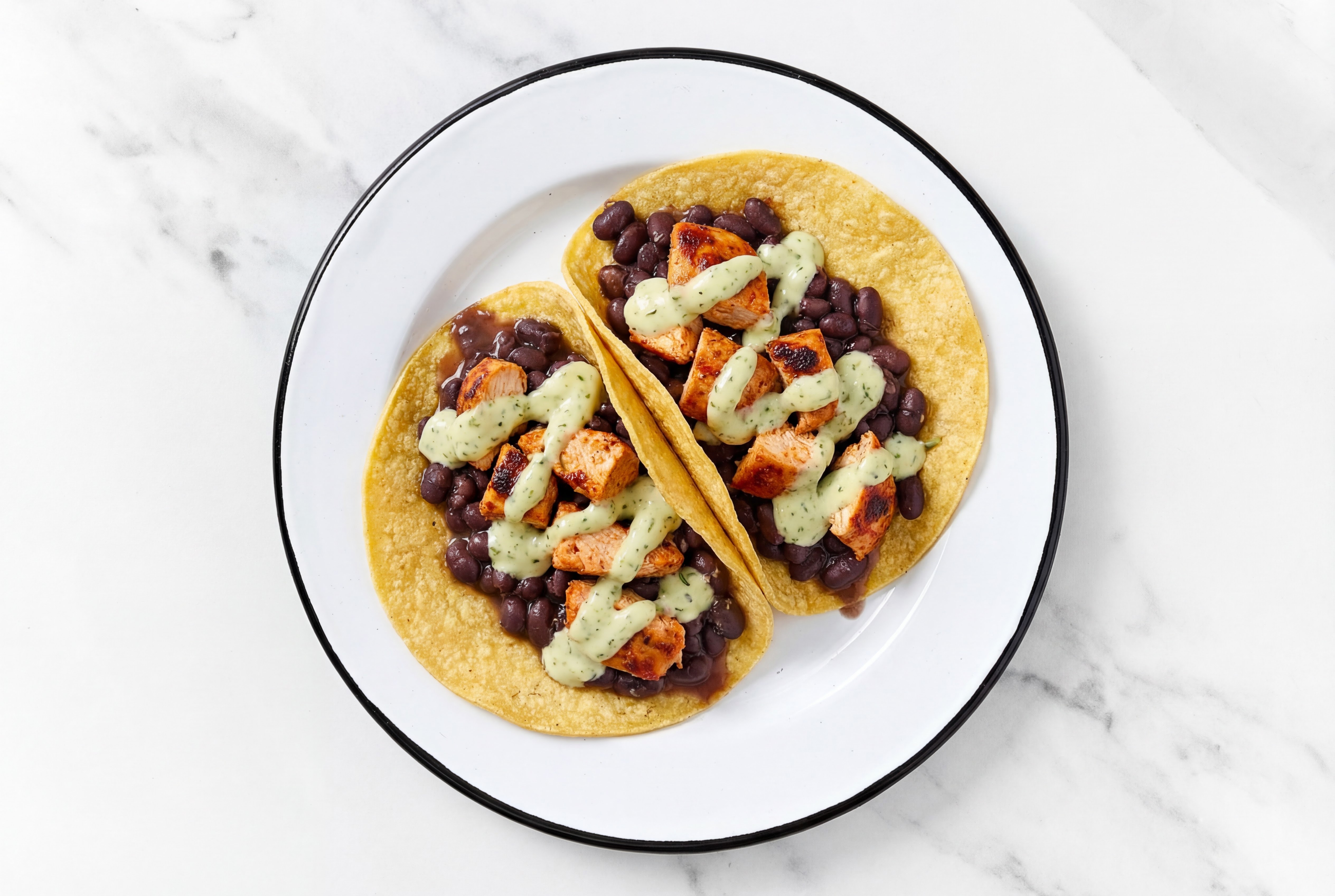 Herby Chipotle Chicken Tacos with Jalapeño Crema & Spiced Beans