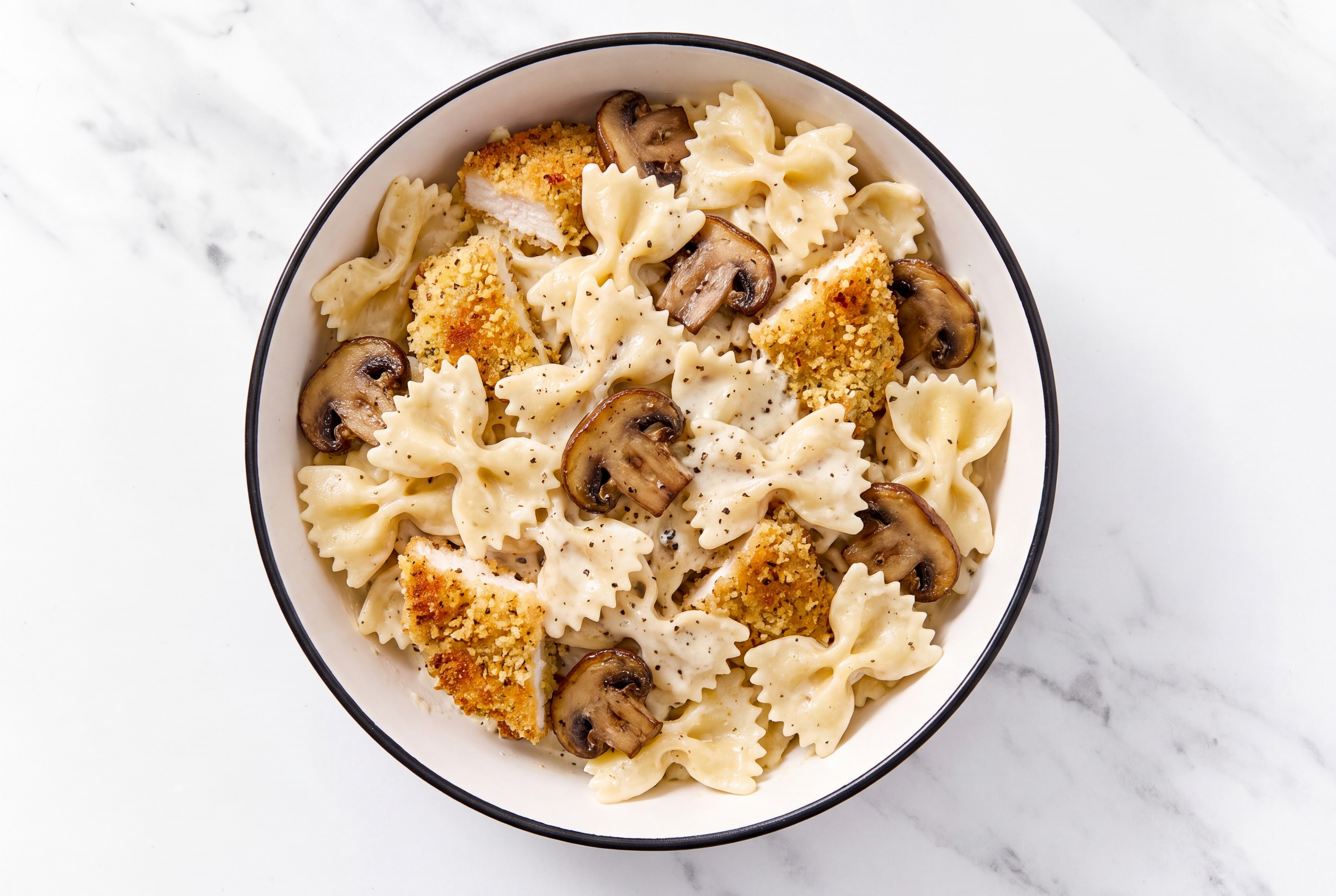 Crispy Garlic Chicken over Alfredo Farfalle with Baby Bella Mushrooms