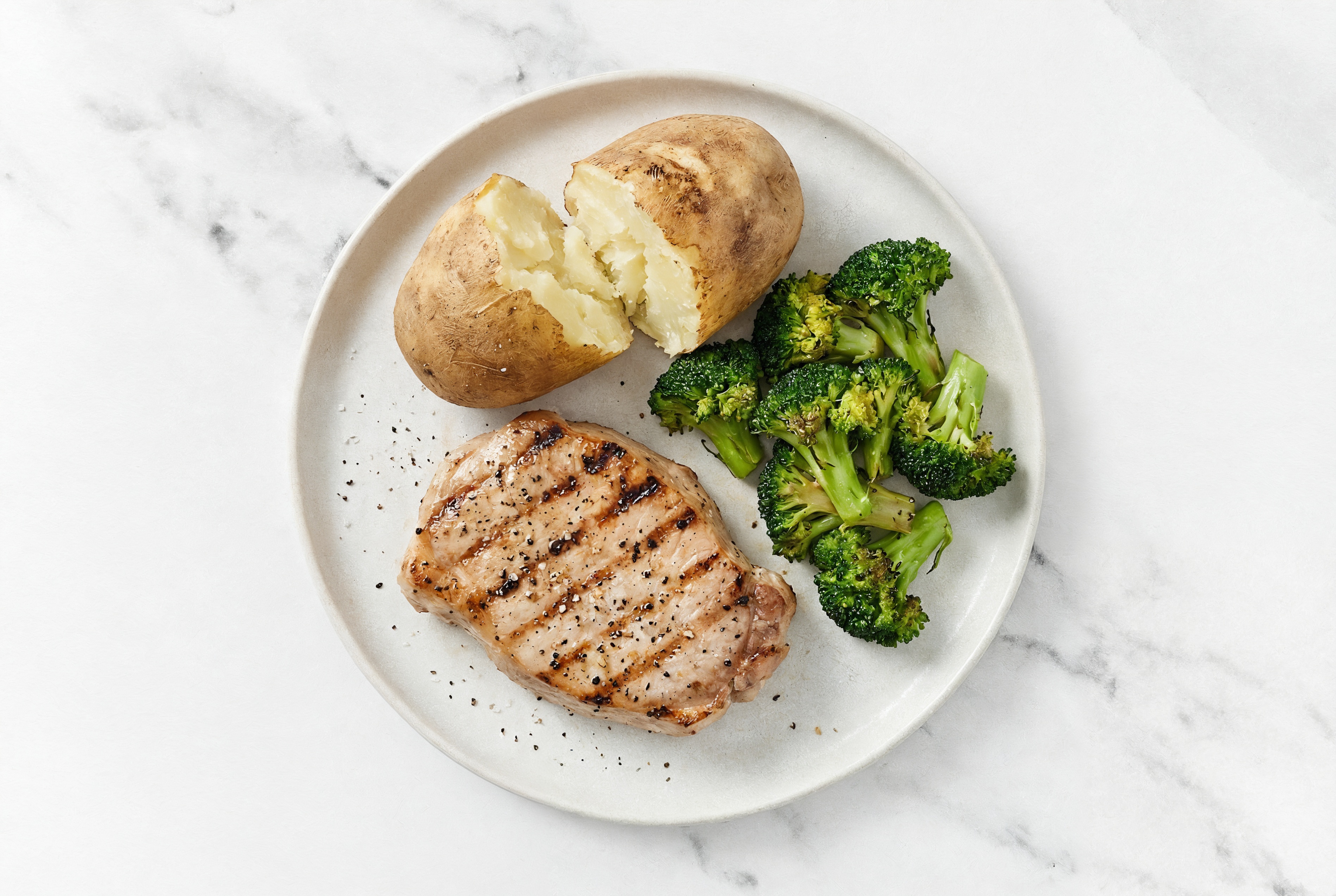 Seared Pork Chop with Baked Microwave-Ready Russet Potato + Broccoli Bunches