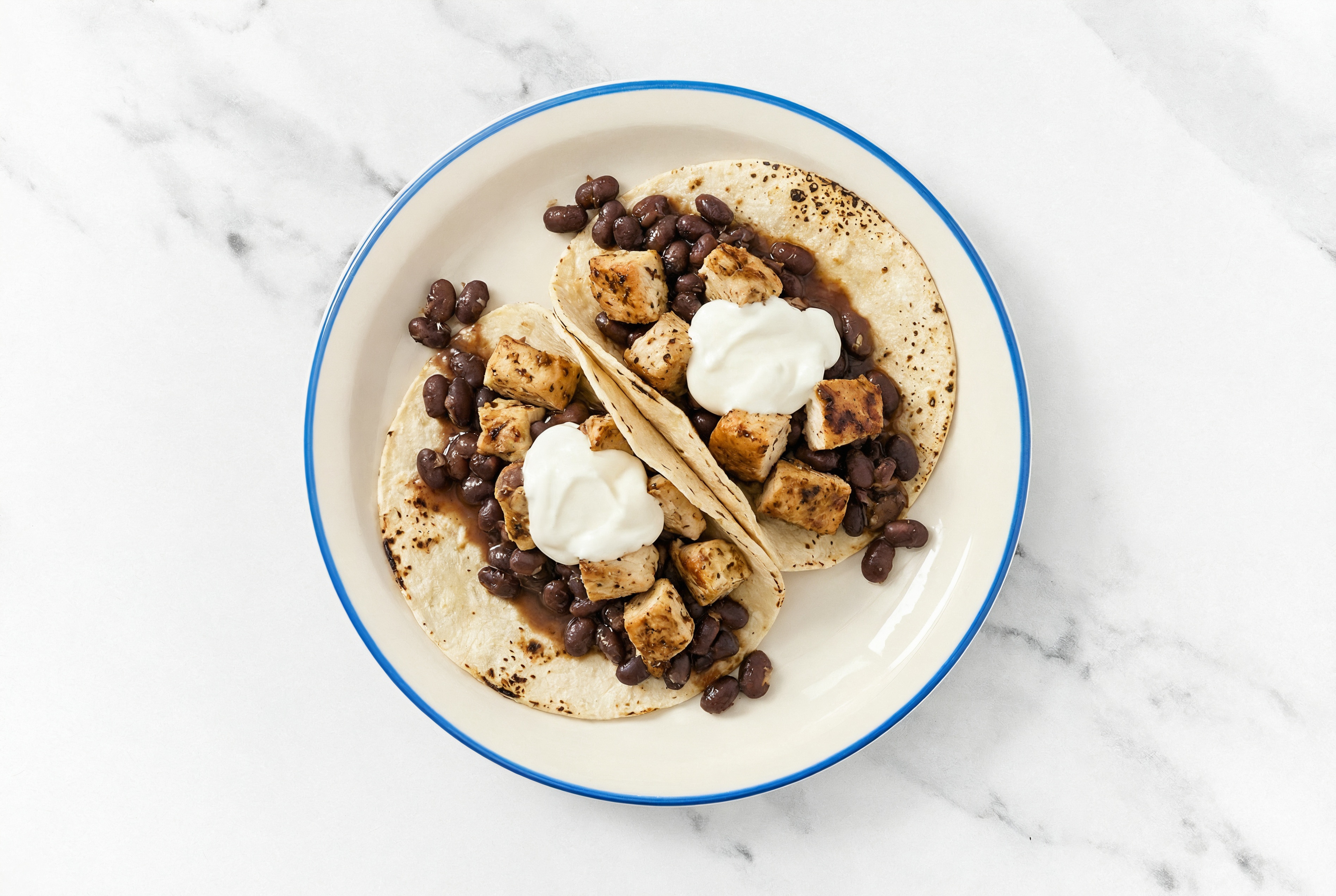 Hearty Garlic Chicken Tacos with Crema & Spiced Beans