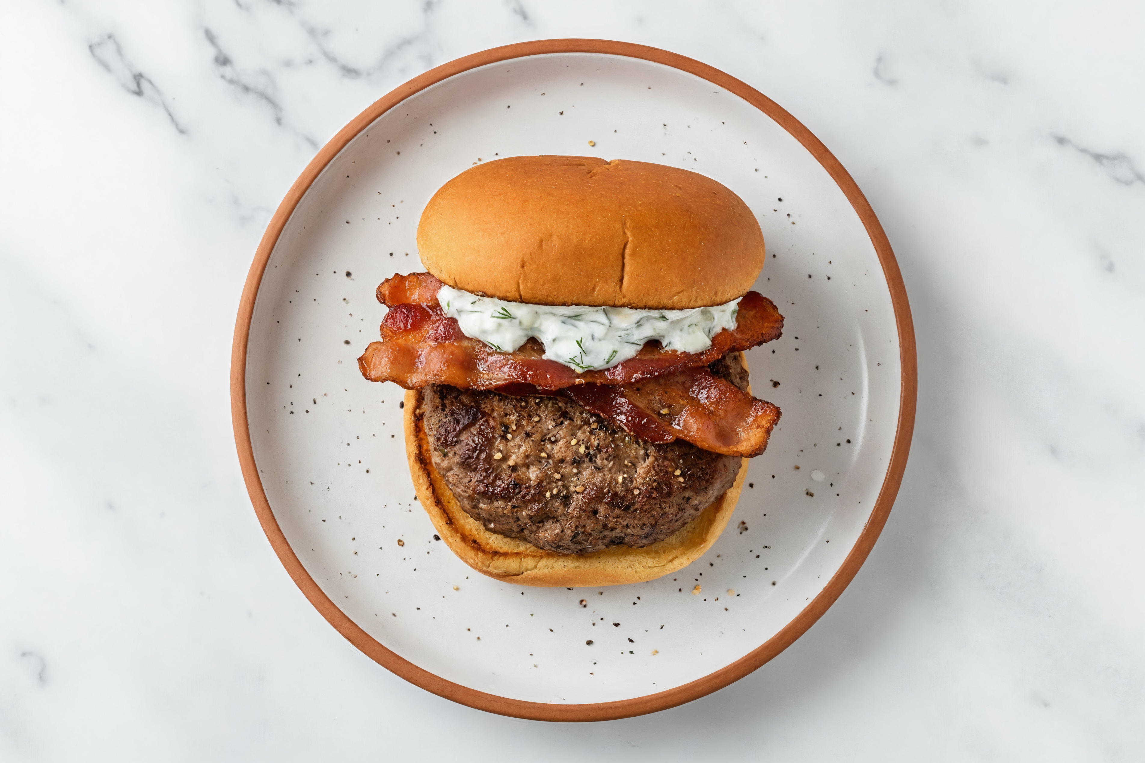 Ground Lamb Burger on Gluten-Free Bun with Tzatziki & Applewood Smoked Pork Bacon
