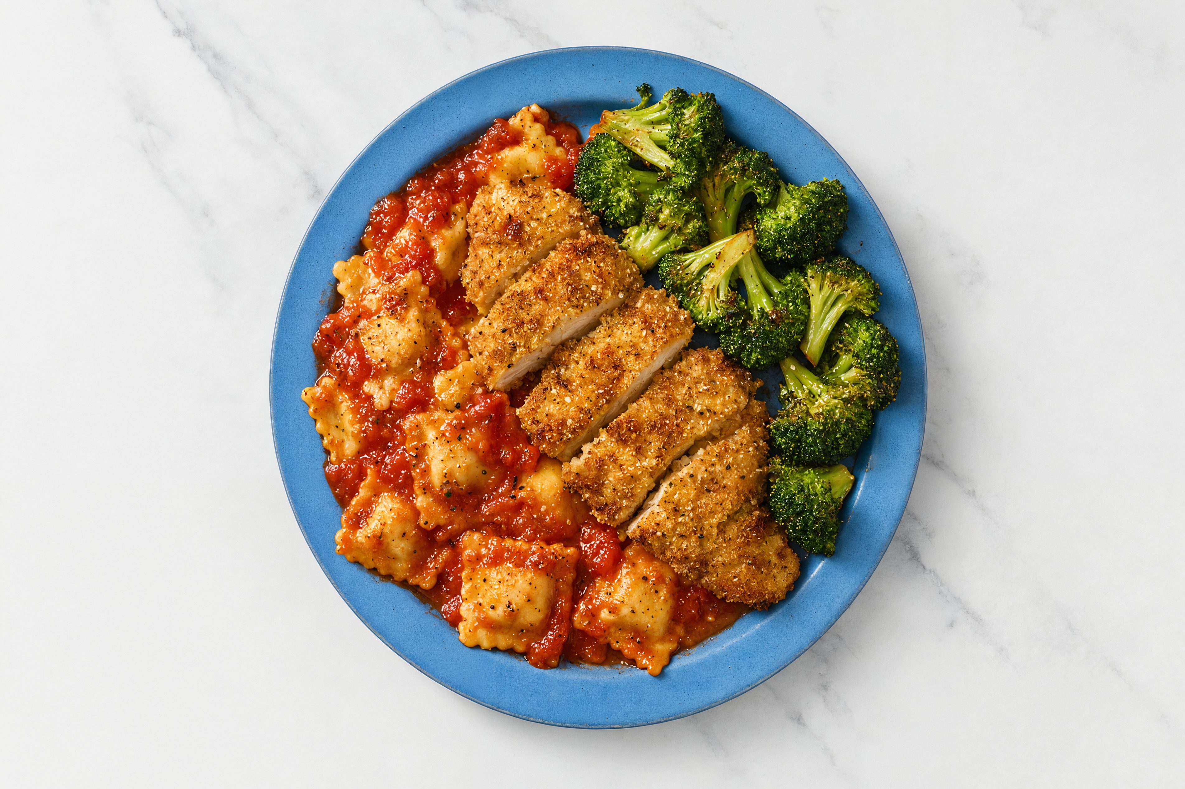 Crispy Garlic Chicken over Marinara Ravioli with Broccoli