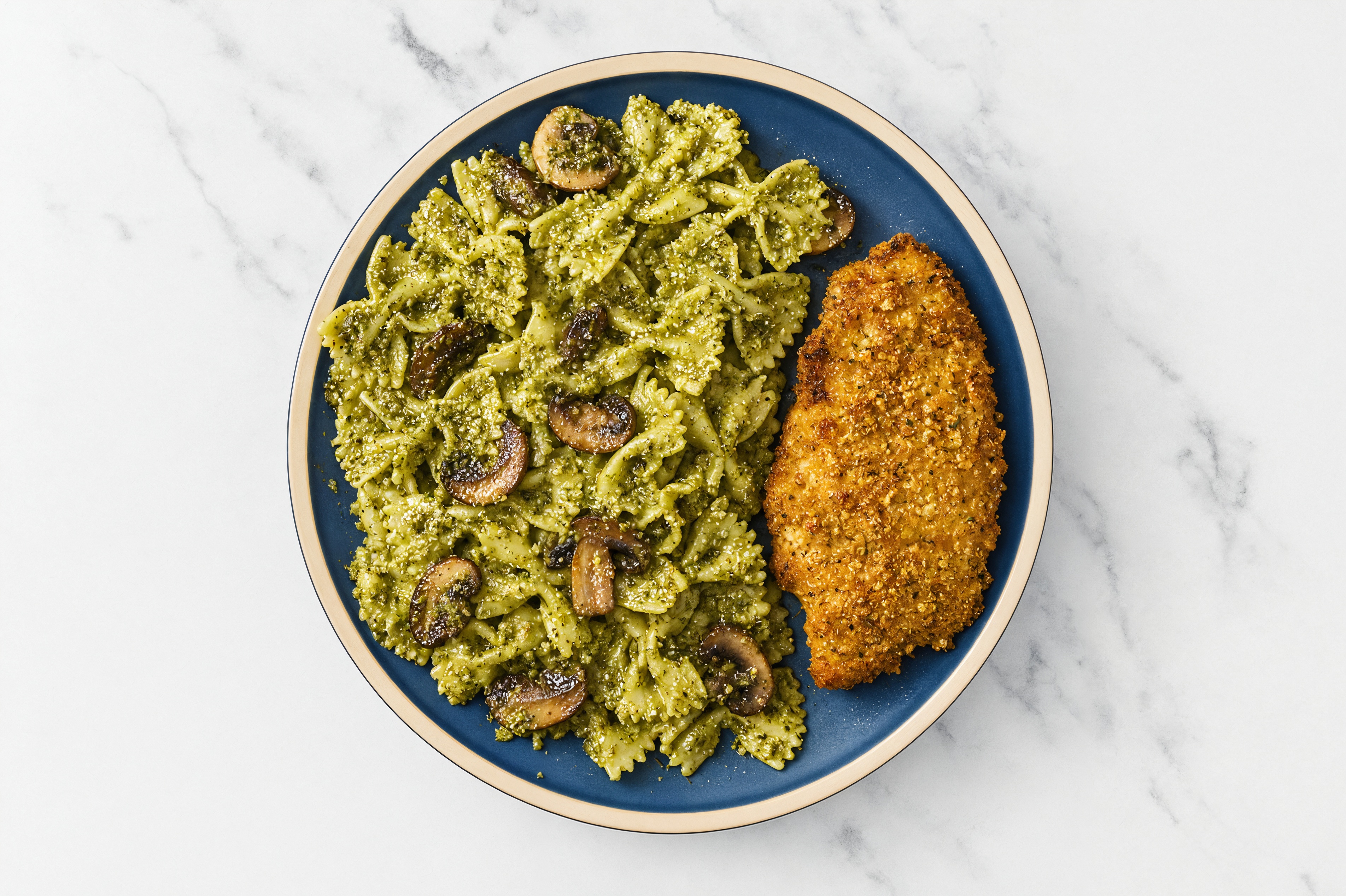 Crispy Garlic Chicken over Pesto Farfalle with Baby Bella Mushrooms