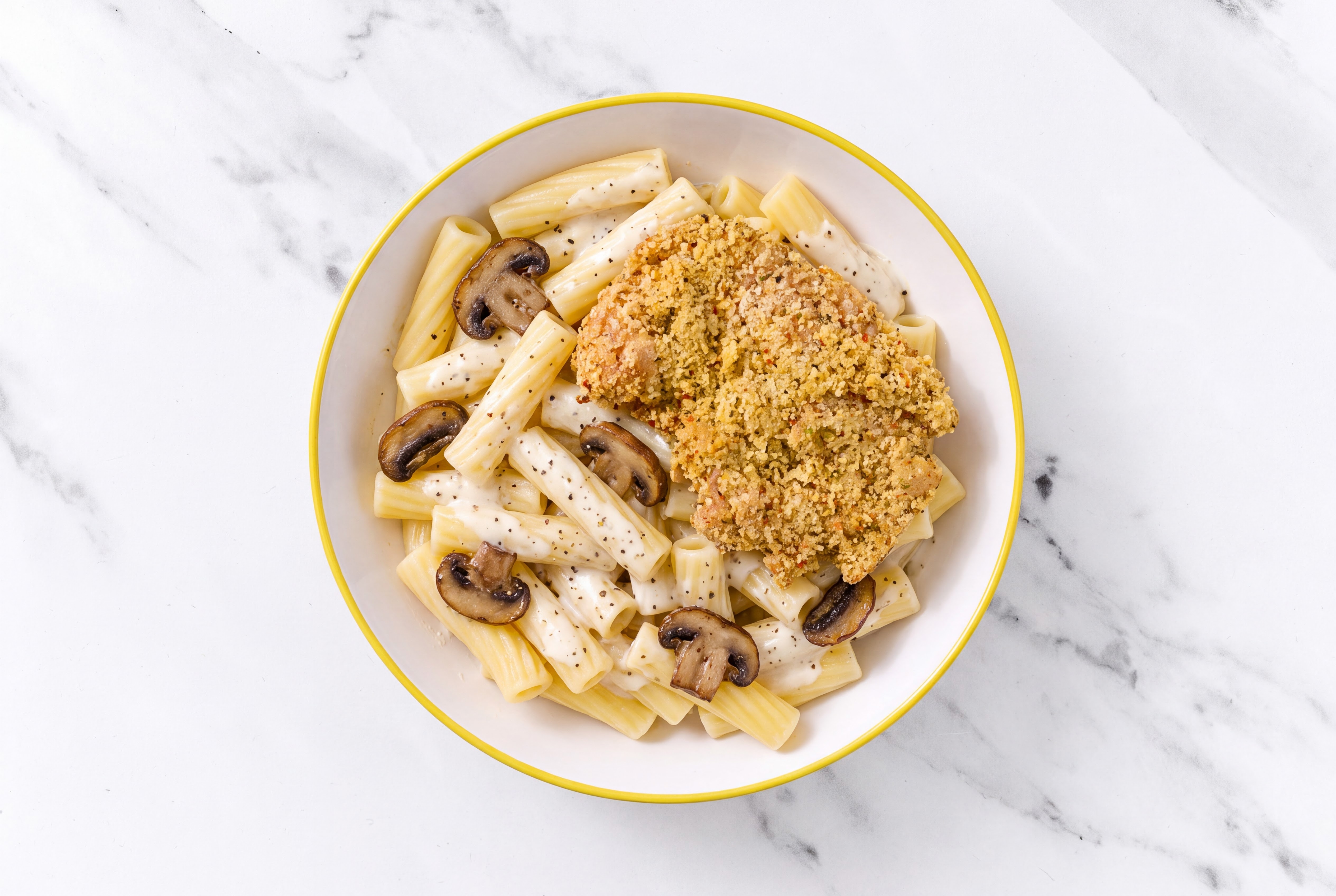 Crispy Garlic Chicken over Alfredo Rigatoni with Baby Bella Mushrooms