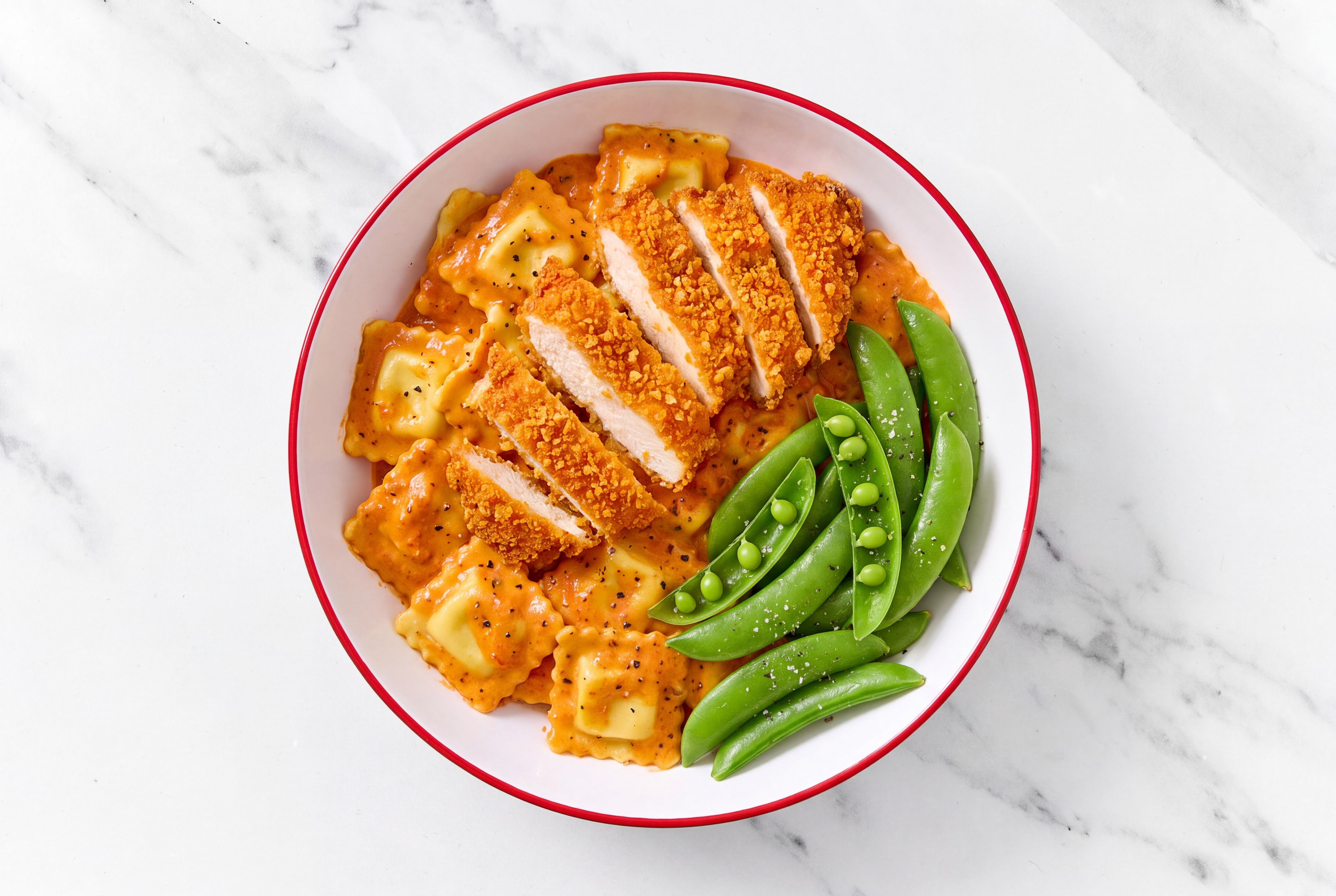 Crispy Hot Honey Chicken over Creamy Vodka Ravioli with Snap Peas