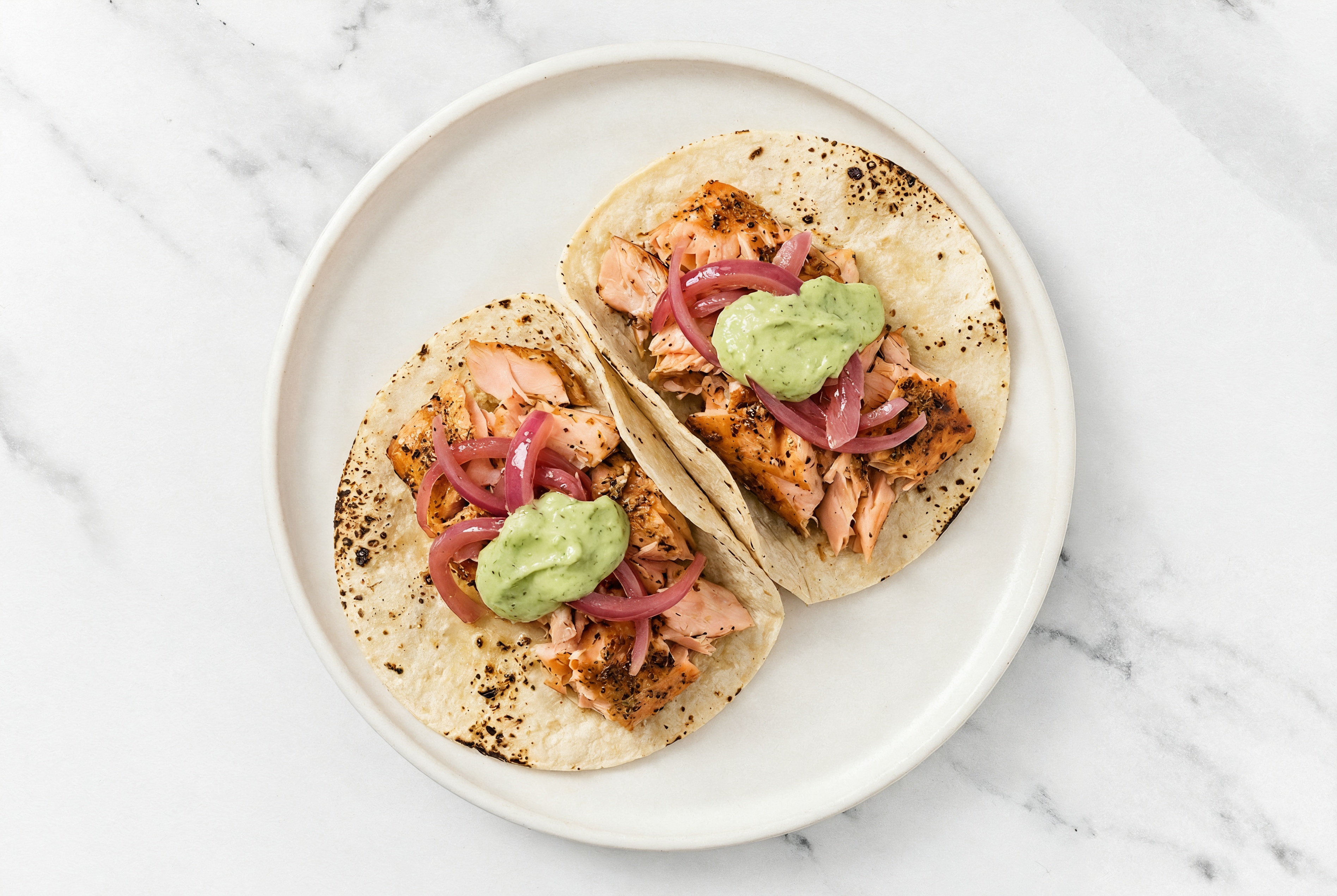 Salmon Tacos with Vegan Pesto Aioli + Pickled Onions