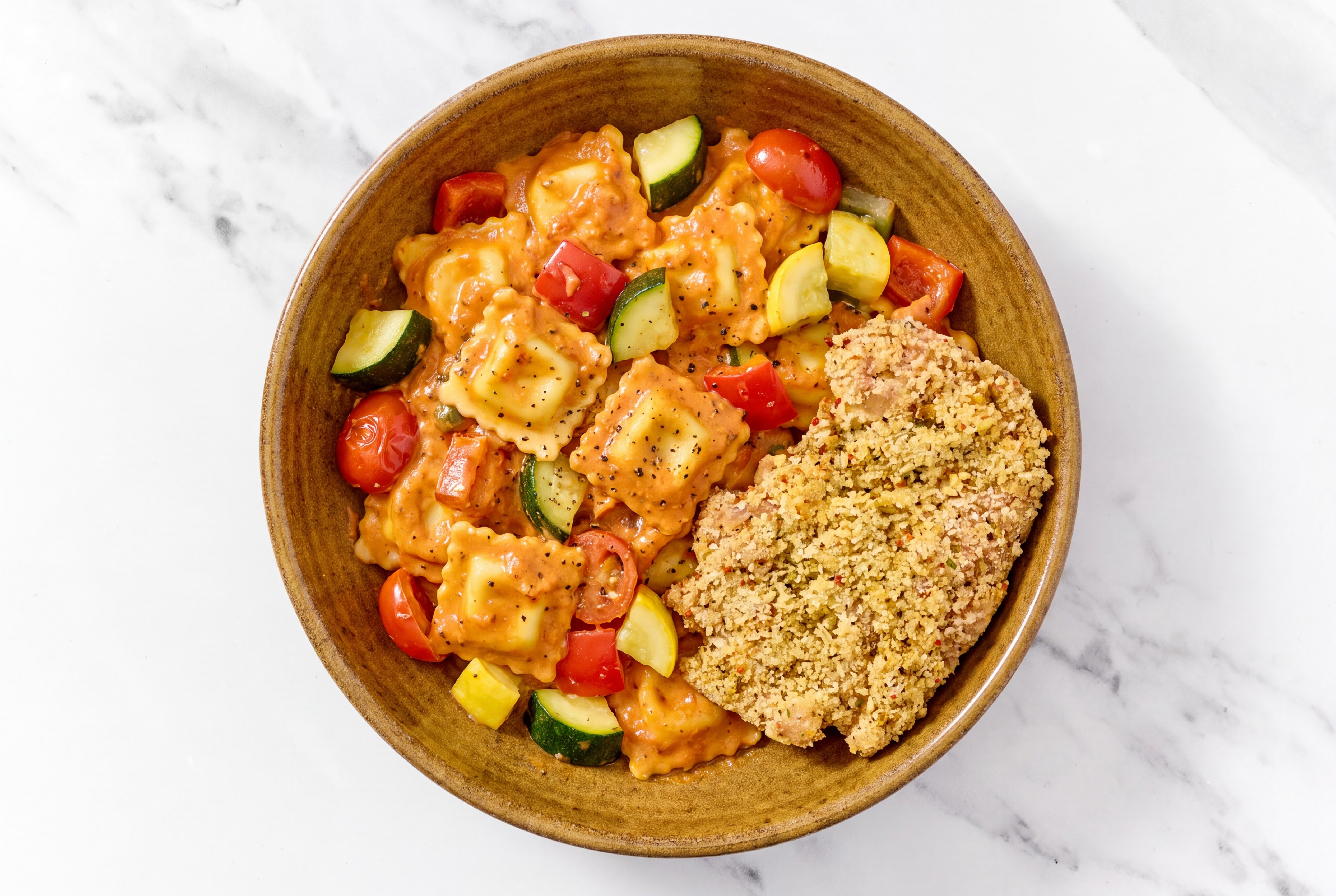 Crispy Garlic Chicken over Creamy Vodka Ravioli with Mixed Veggies