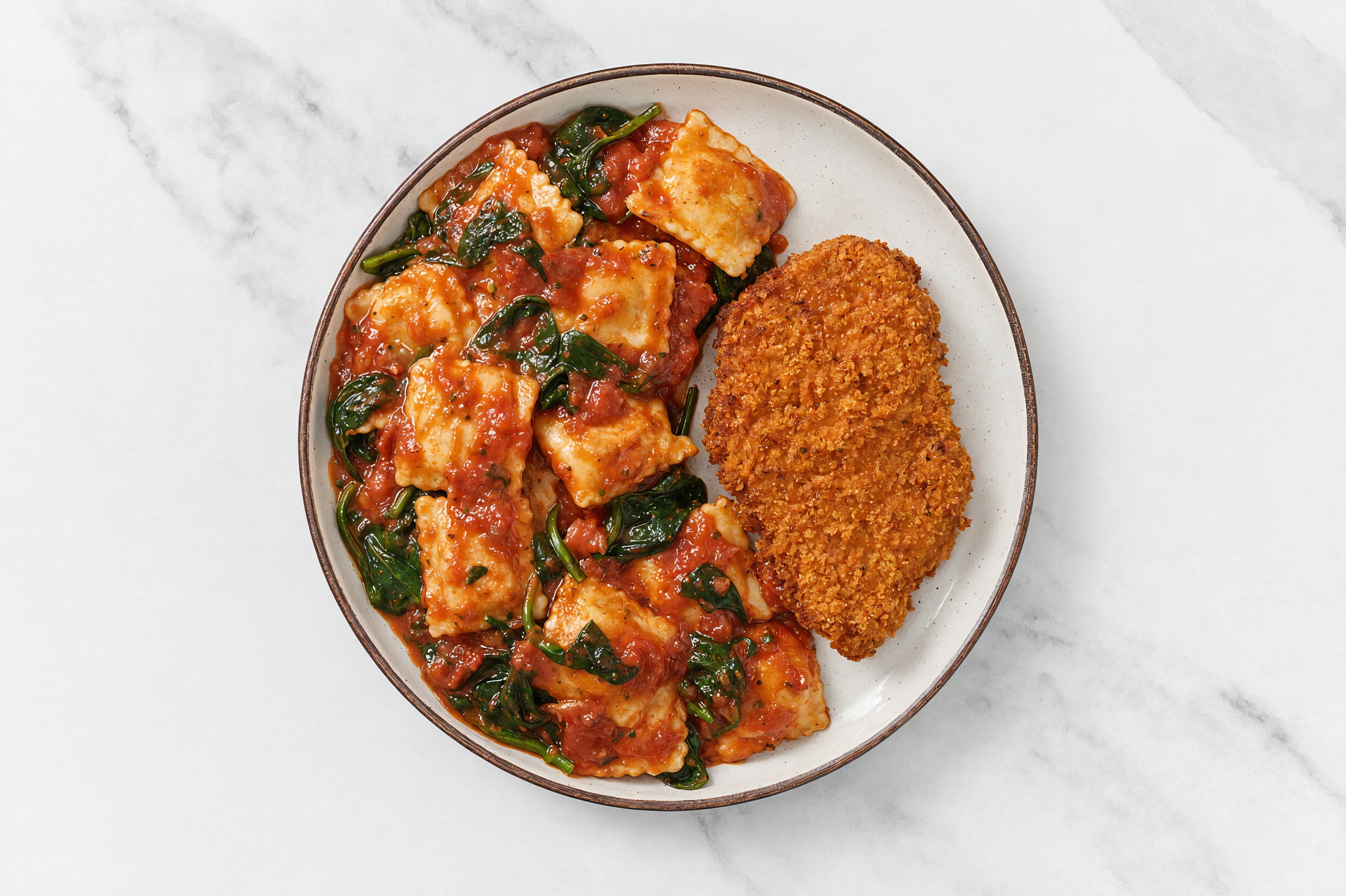 Crispy Hot Honey Chicken over Marinara Ravioli with Baby Spinach
