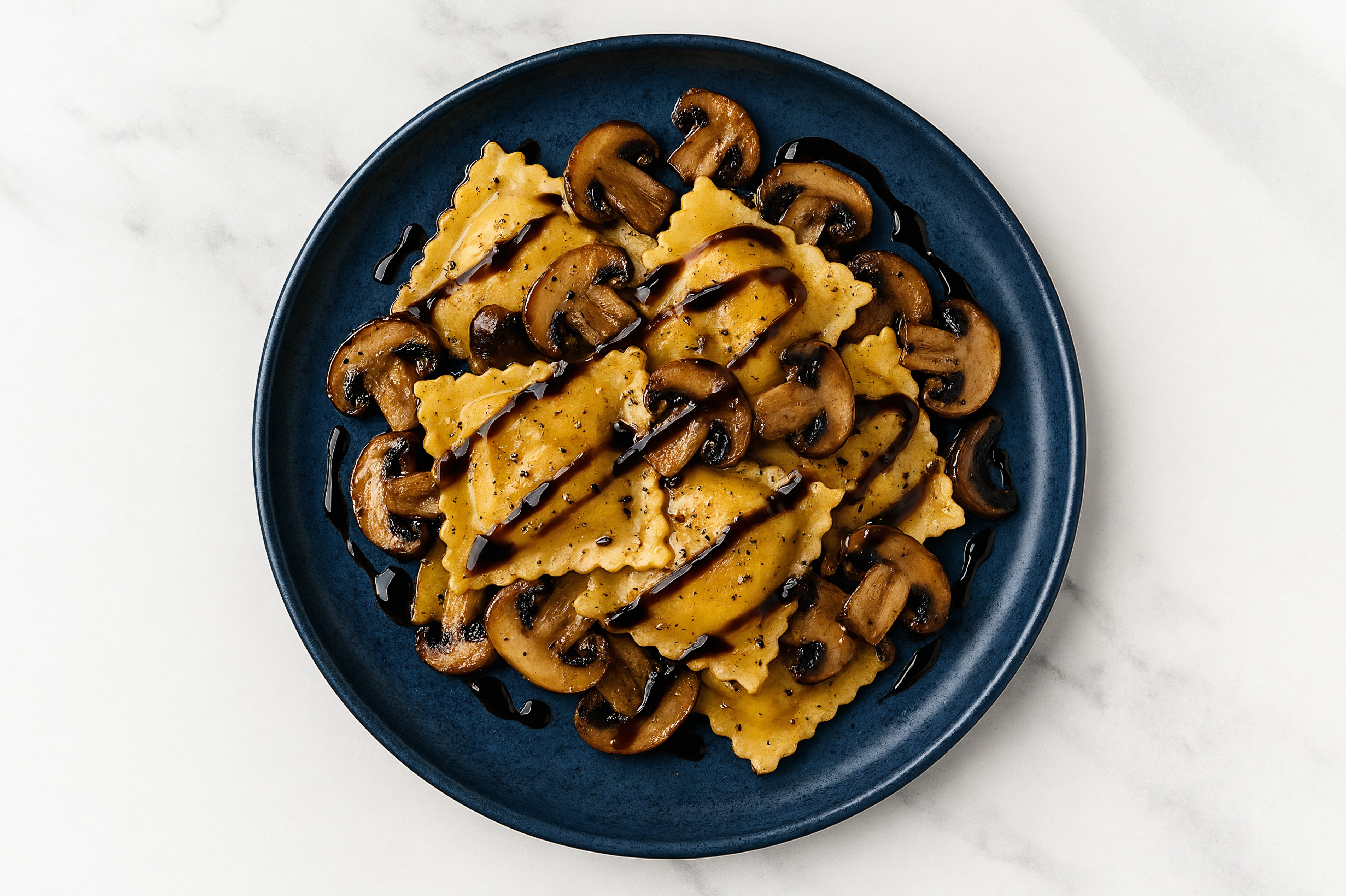 Garlic Slow Churned Herb Pasture Butter Mushroom Squash Ravioli with Balsamic Reduction