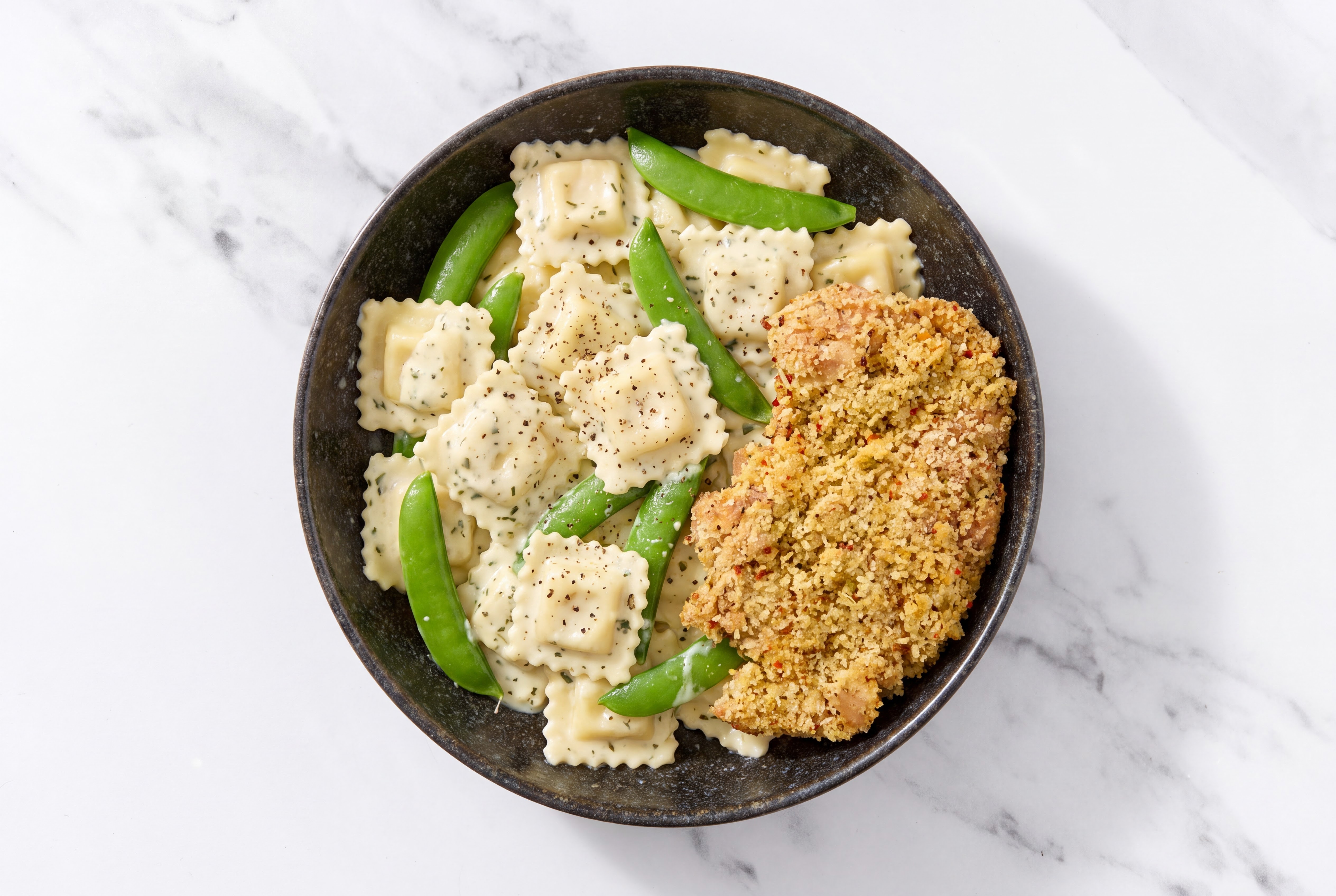 Crispy Garlic Chicken over Creamy Ravioli with Snap Peas