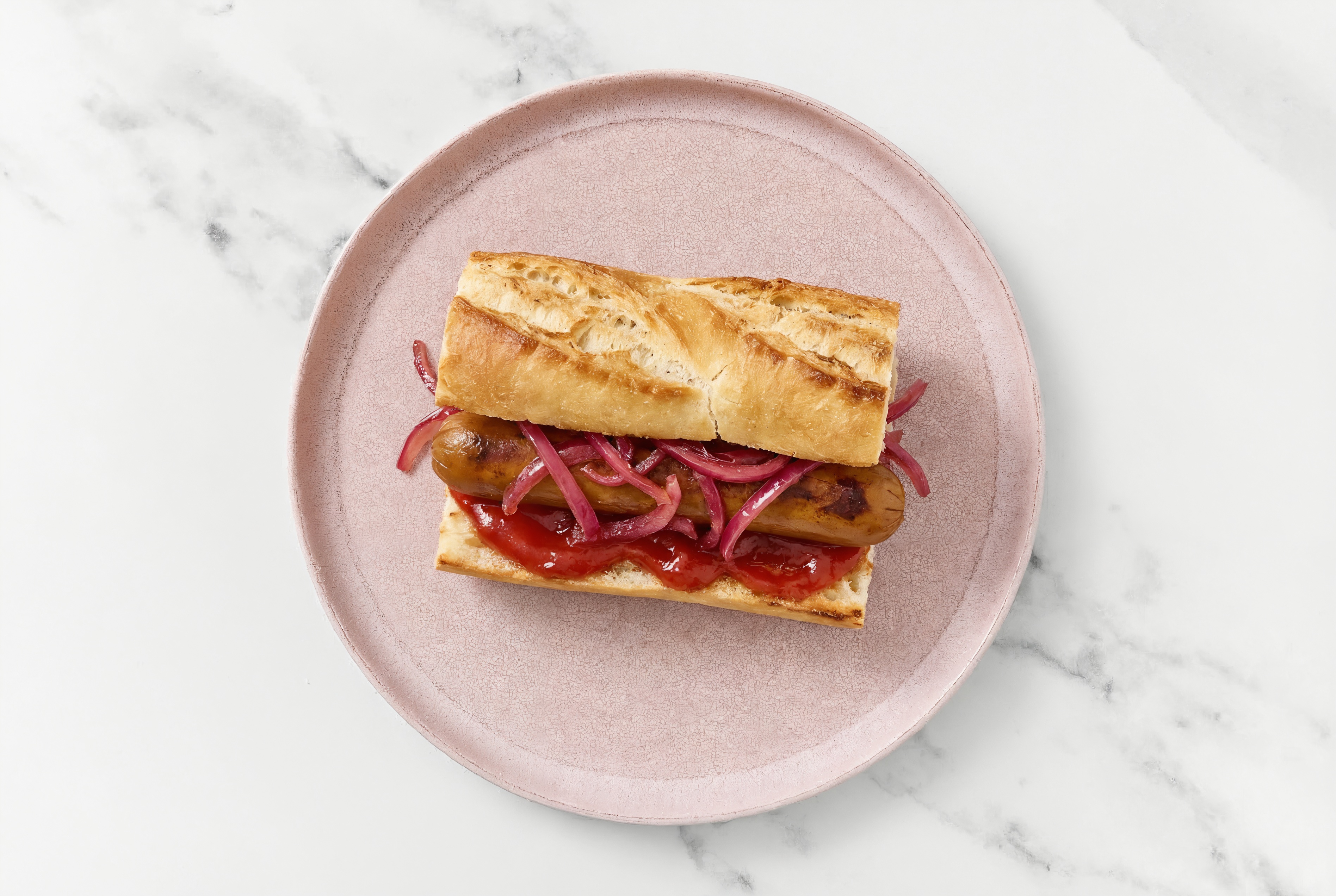 Pickled Red Onion Smart Dog with Ketchup on Baguette