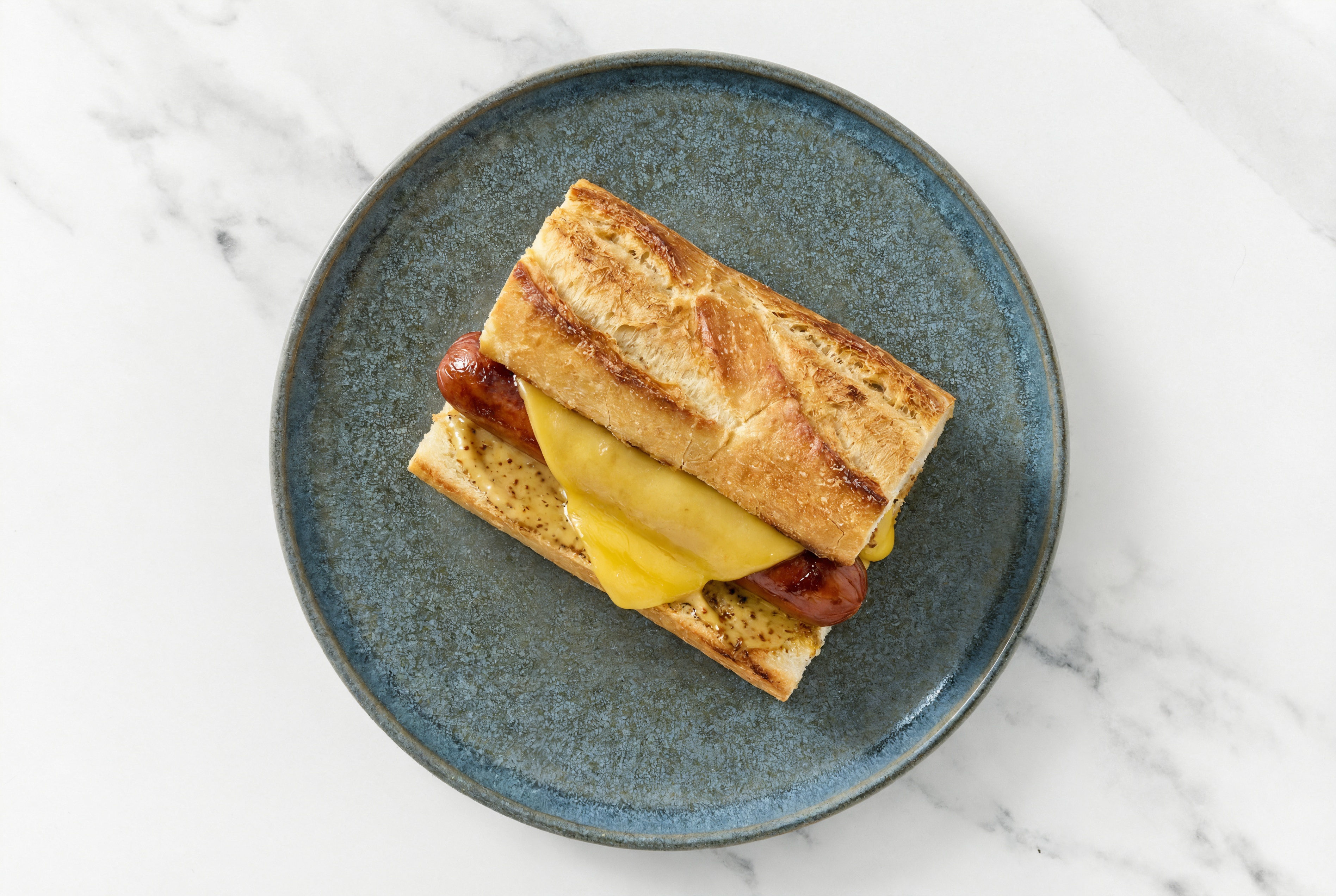 Vegan Cheddar Beef Hot Dog with Honey Mustard on Baguette