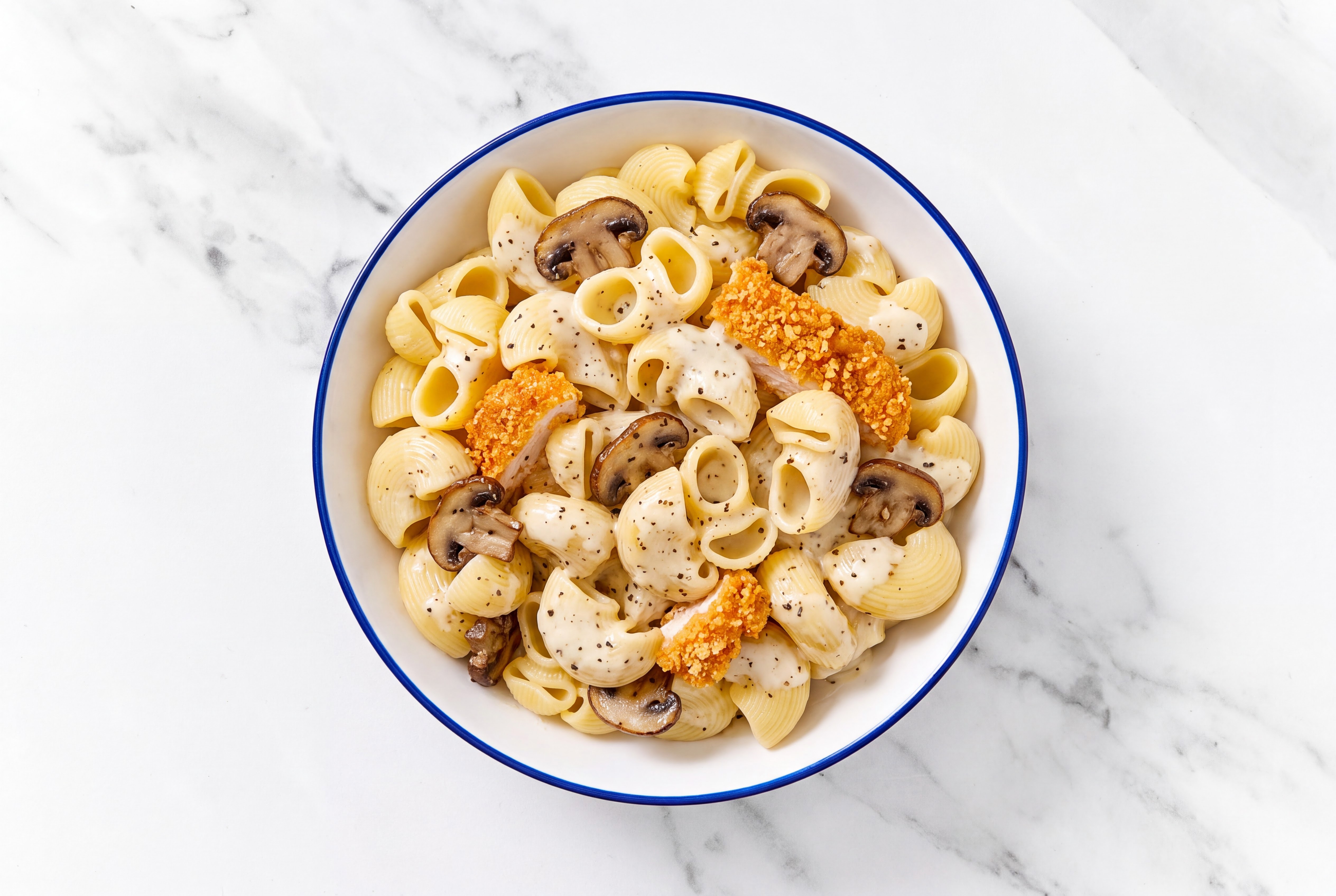 Crispy Hot Honey Chicken over Alfredo Chiocciole Pasta with Baby Bella Mushrooms