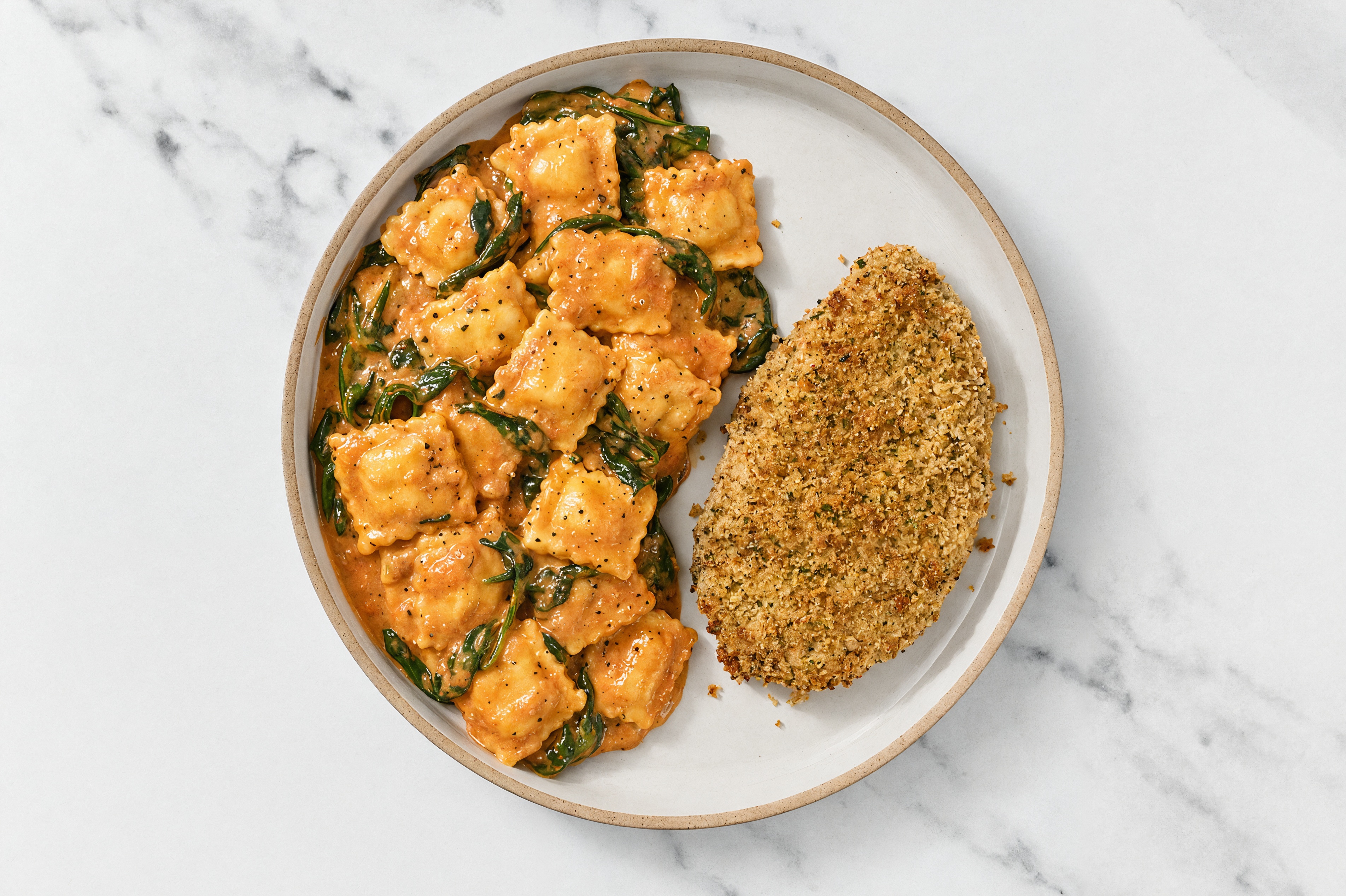 Crispy Garlic Chicken over Creamy Vodka Ravioli with Baby Spinach