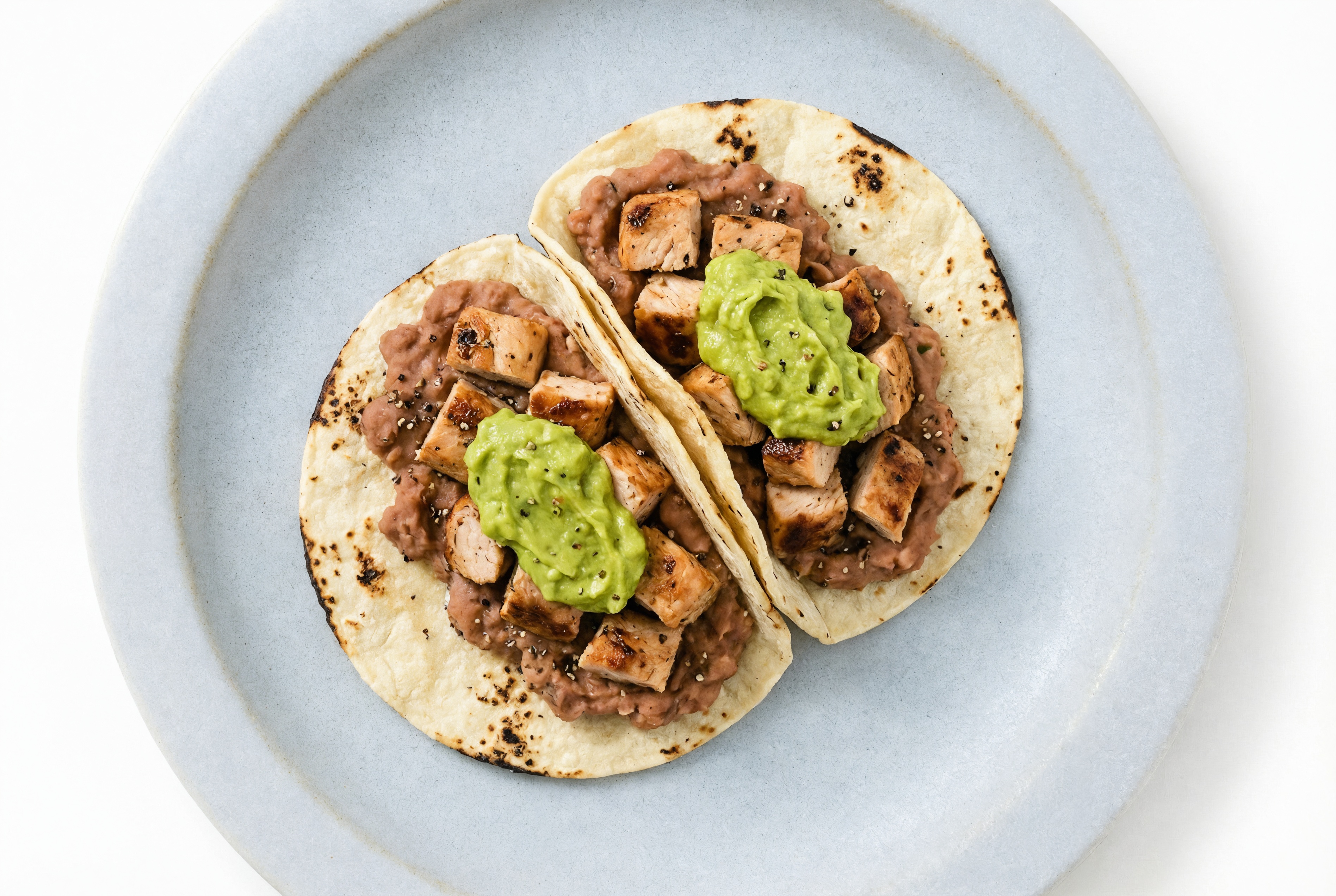 Hearty Chipotle Turkey Tacos with Guacamole & Refried Red Beans