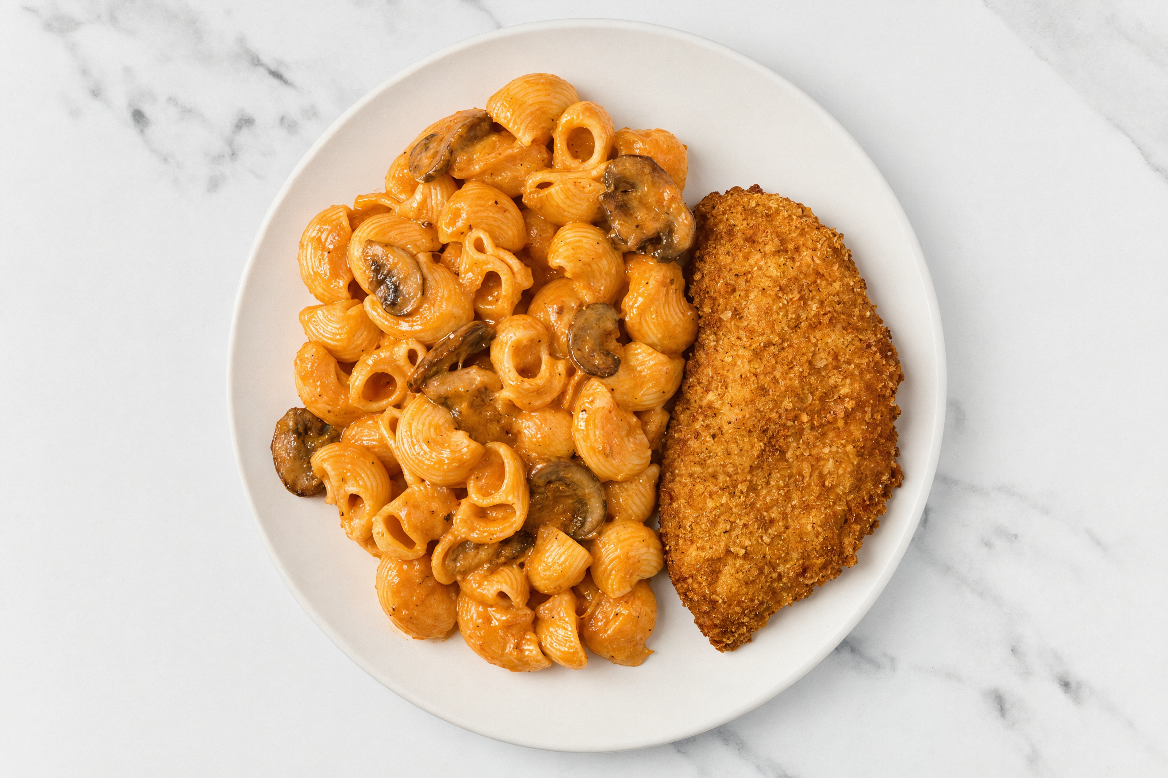 Crispy Hot Honey Chicken over Creamy Vodka Chiocciole Pasta with Baby Bella Mushrooms