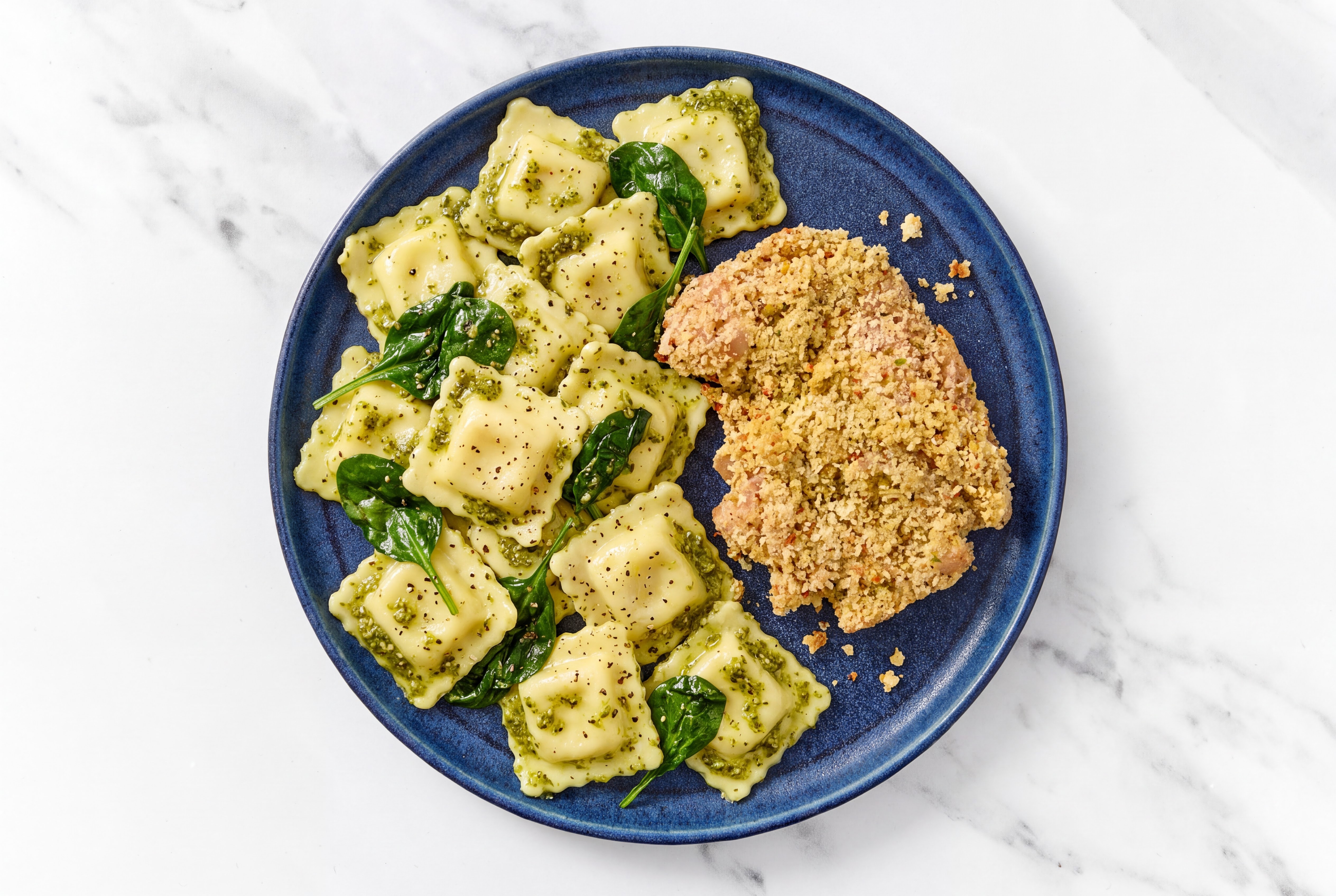 Crispy Garlic Chicken over Pesto Ravioli with Baby Spinach
