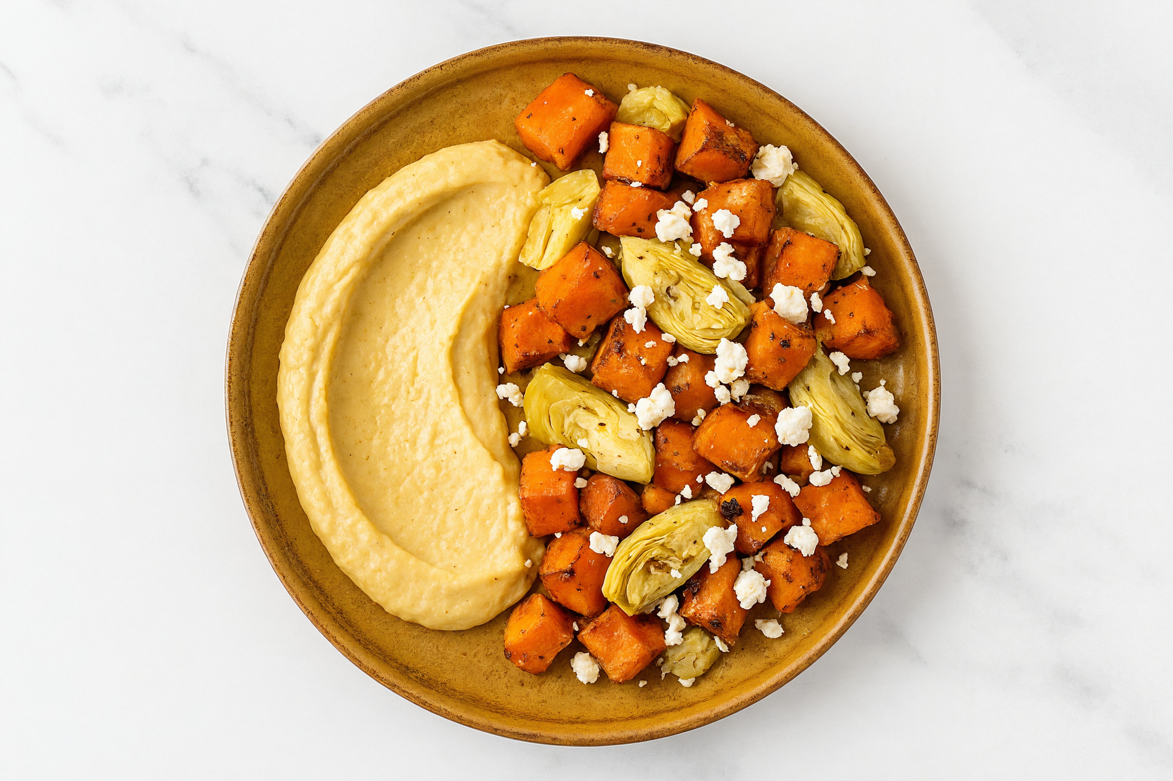 Crumbled Chevre Artichoke Sweet Potato Bowl over Lemon Garlic Hummus