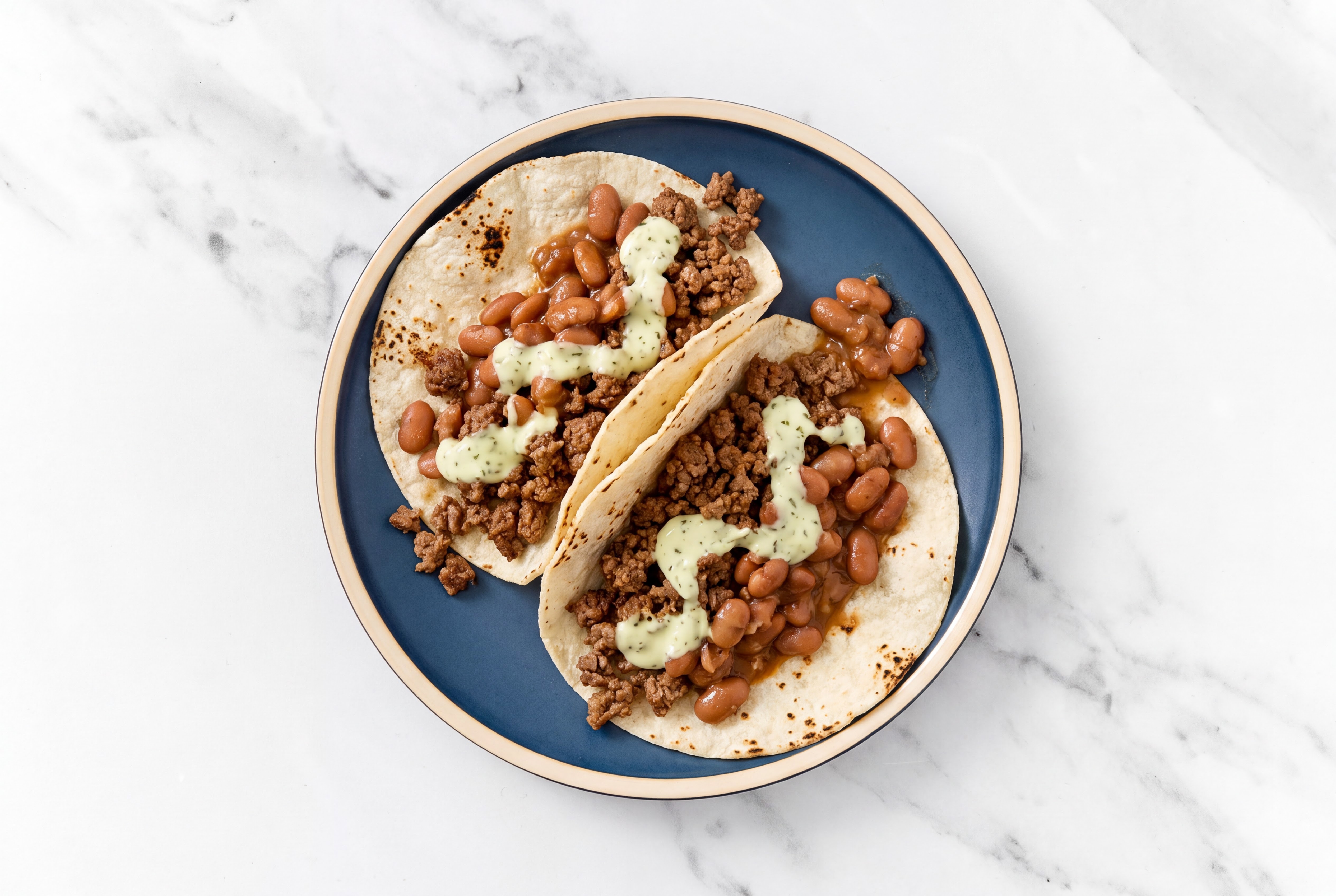 Hearty Ground 93/7 Lean Beef Tacos with Jalapeño Crema & Pinto Beans