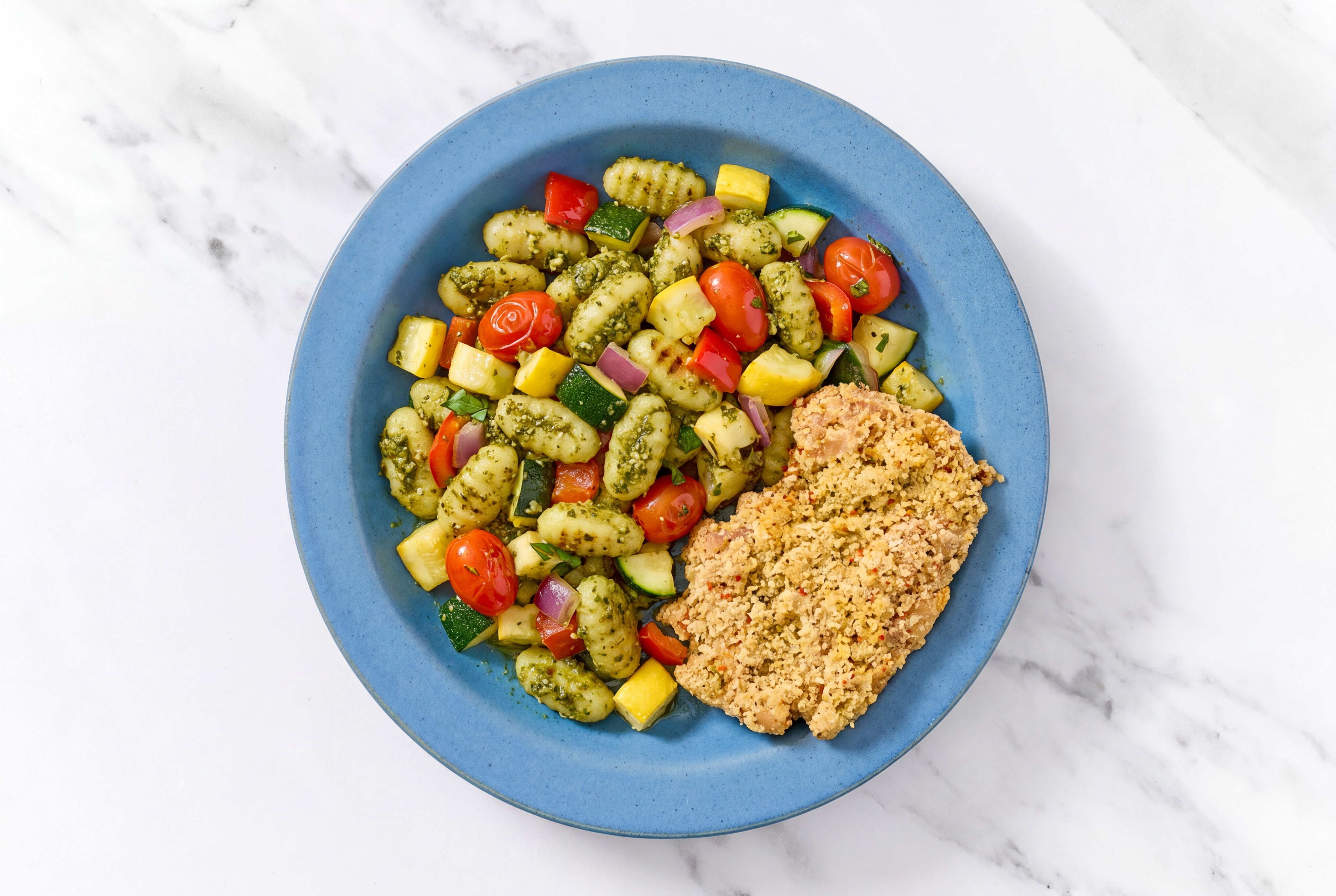 Crispy Garlic Chicken over Pesto Gnocchi with Mixed Veggies