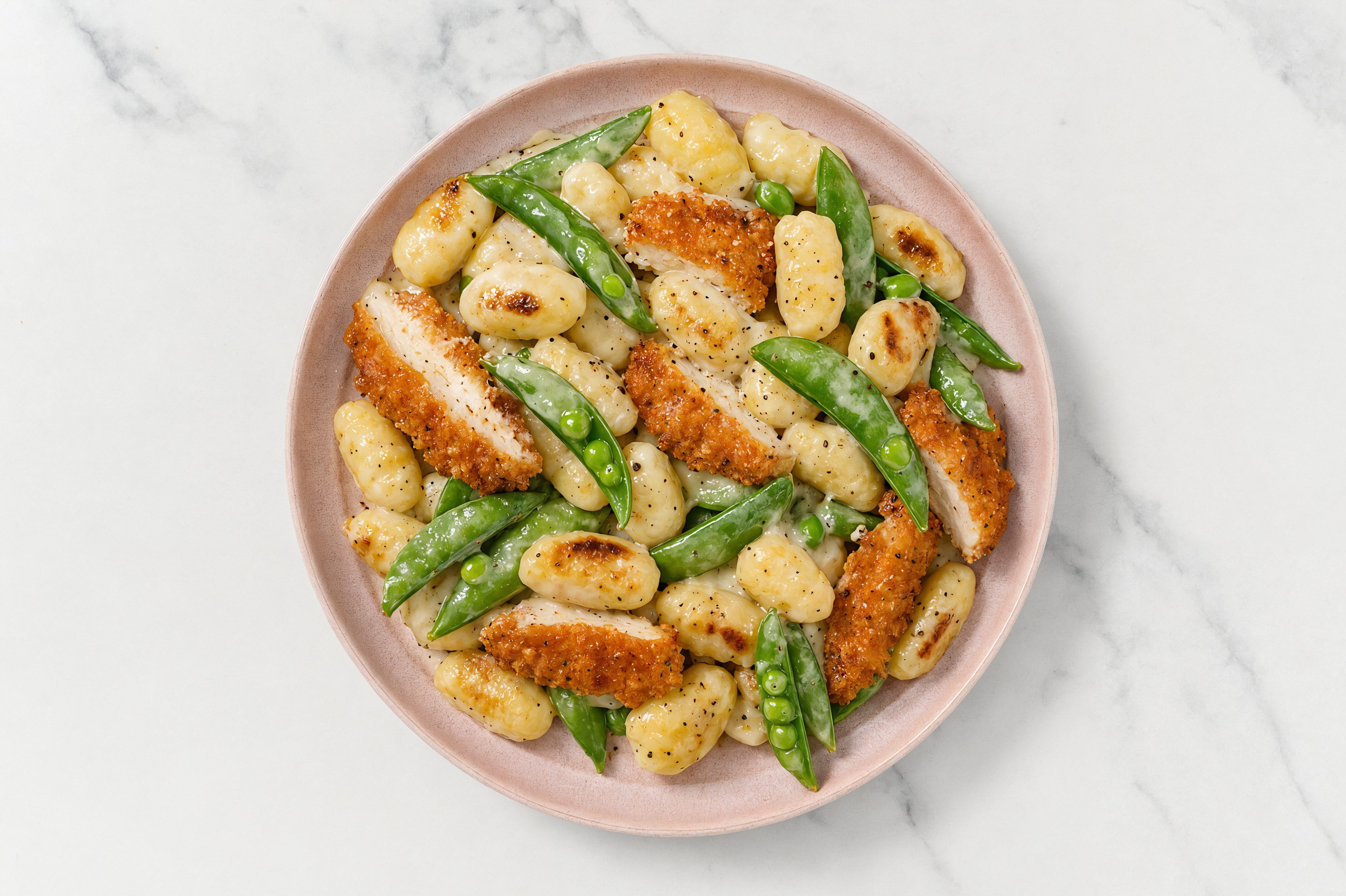 Crispy Hot Honey Chicken over Alfredo Gnocchi with Snap Peas