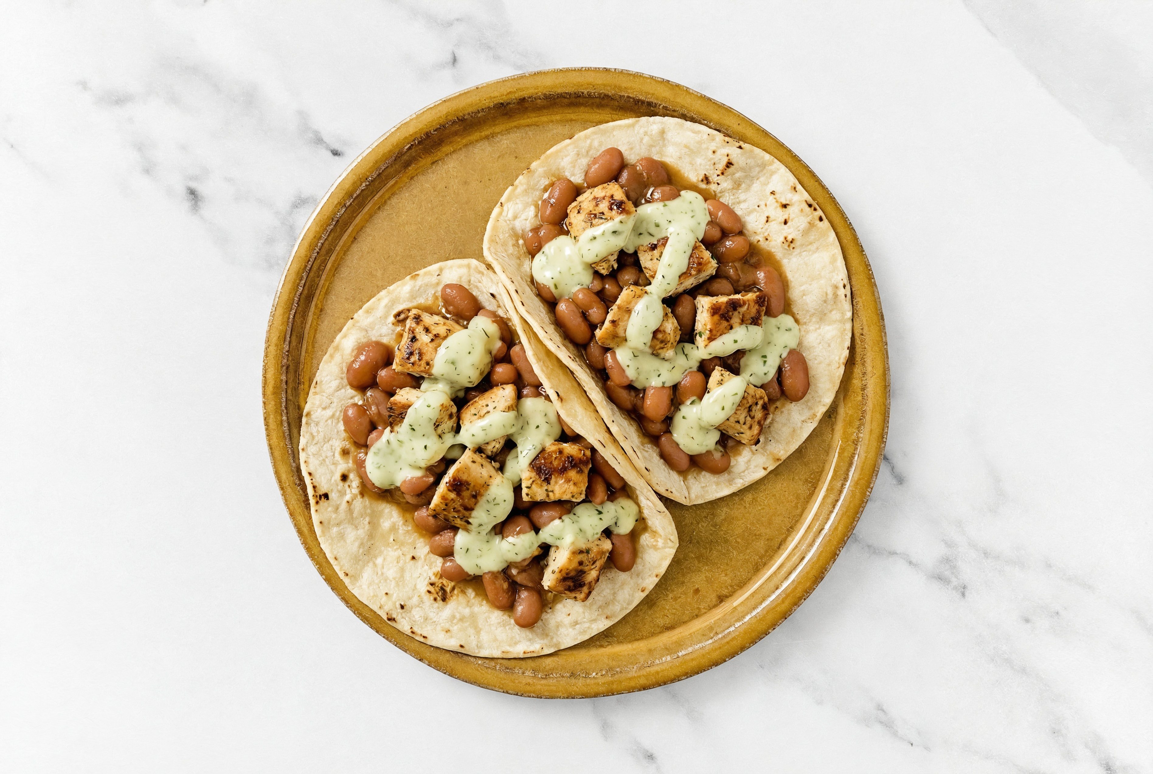 Hearty Garlic Chicken Tacos with Jalapeño Crema & Pinto Beans