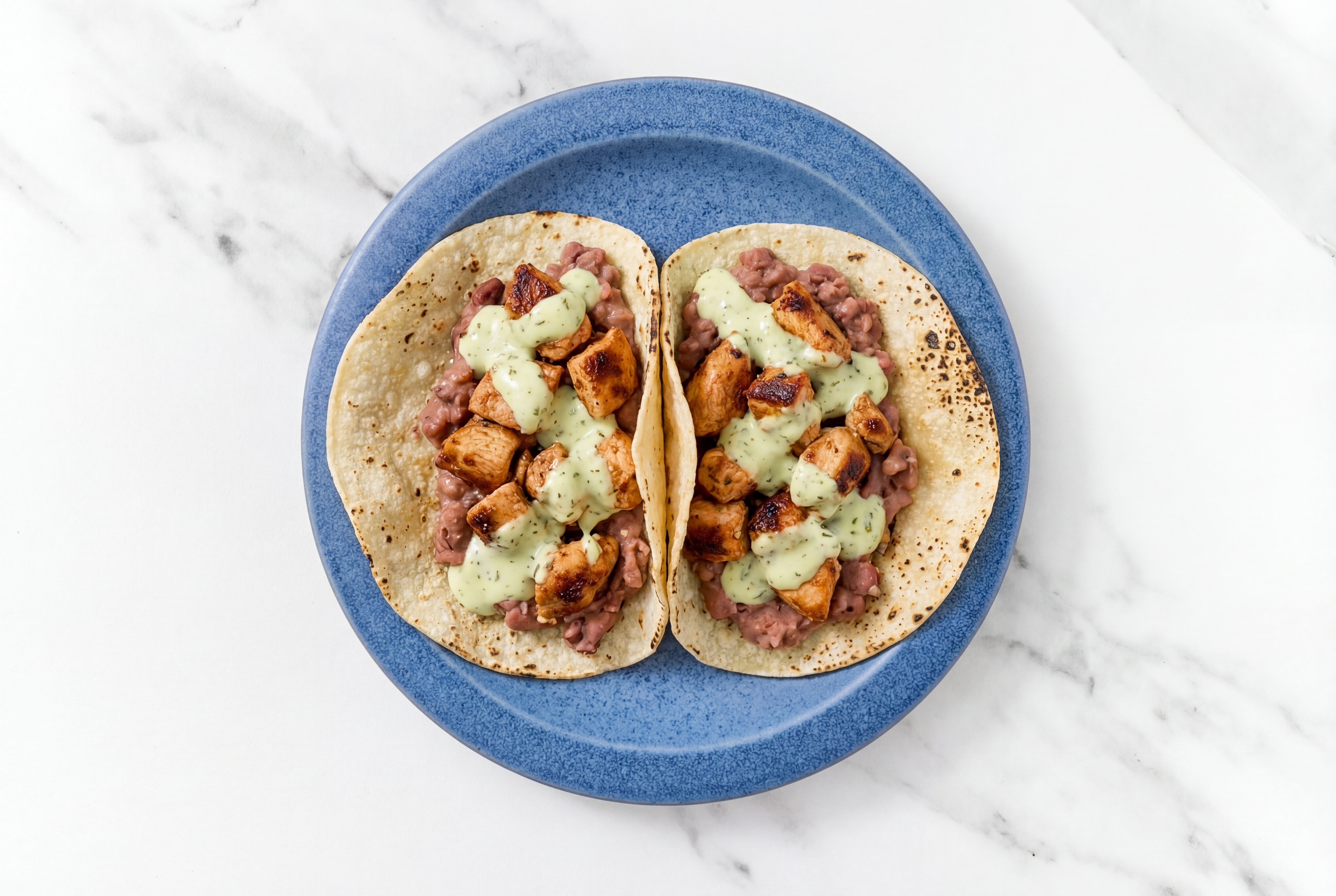 Hearty Chipotle Chicken Tacos with Jalapeño Crema & Refried Red Beans