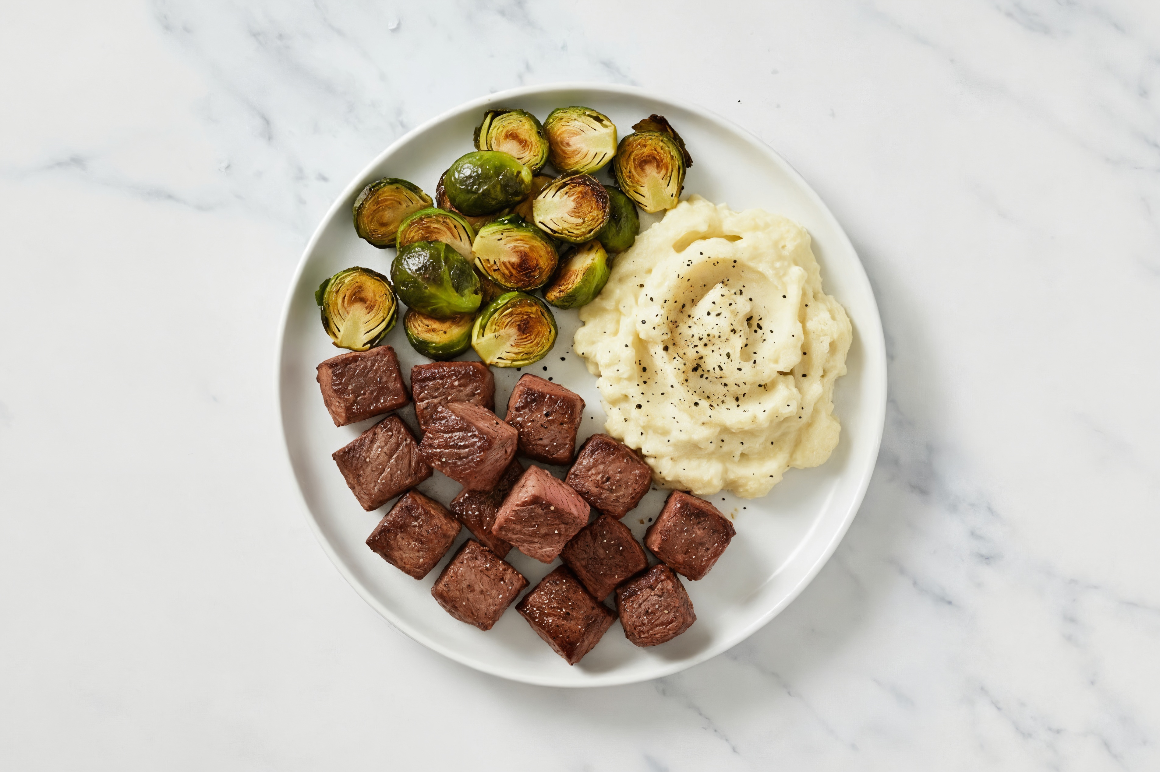 Sirloin Beef Tips with Crispy Brussels + Cauliflower Mash